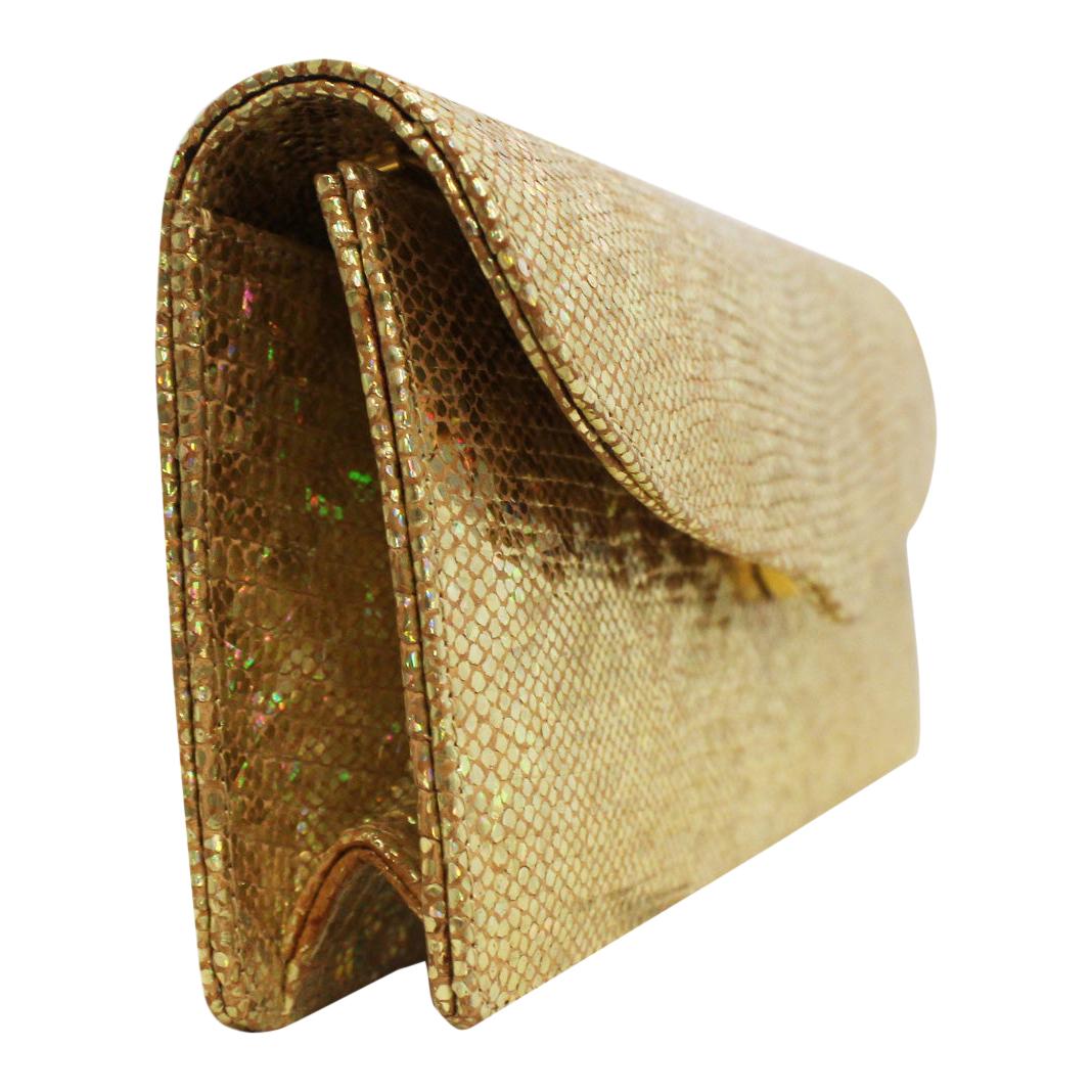 Lana Marks gold tone glitter clutch bag can, also, be worn as a cross body.  It is an exceptional perfect little wear with everything and anything bag.   Some smart phones will fit.  This bag contains one side slit pocket.  For closure, a magnetic