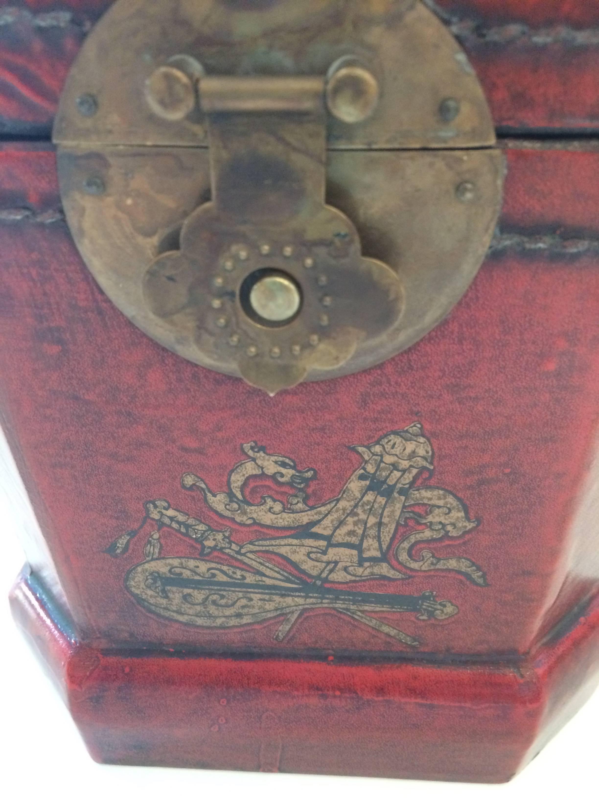 Wunderschöne chinesische Schachtel in Rot, Gold und Schwarz mit einem gemalten Chinoiserie-Motiv auf geprägtem Leder und originalen Messingbeschlägen. Es gibt eine herausnehmbare Metallauskleidung und das Innere ist mit schönem chinesischen Papier