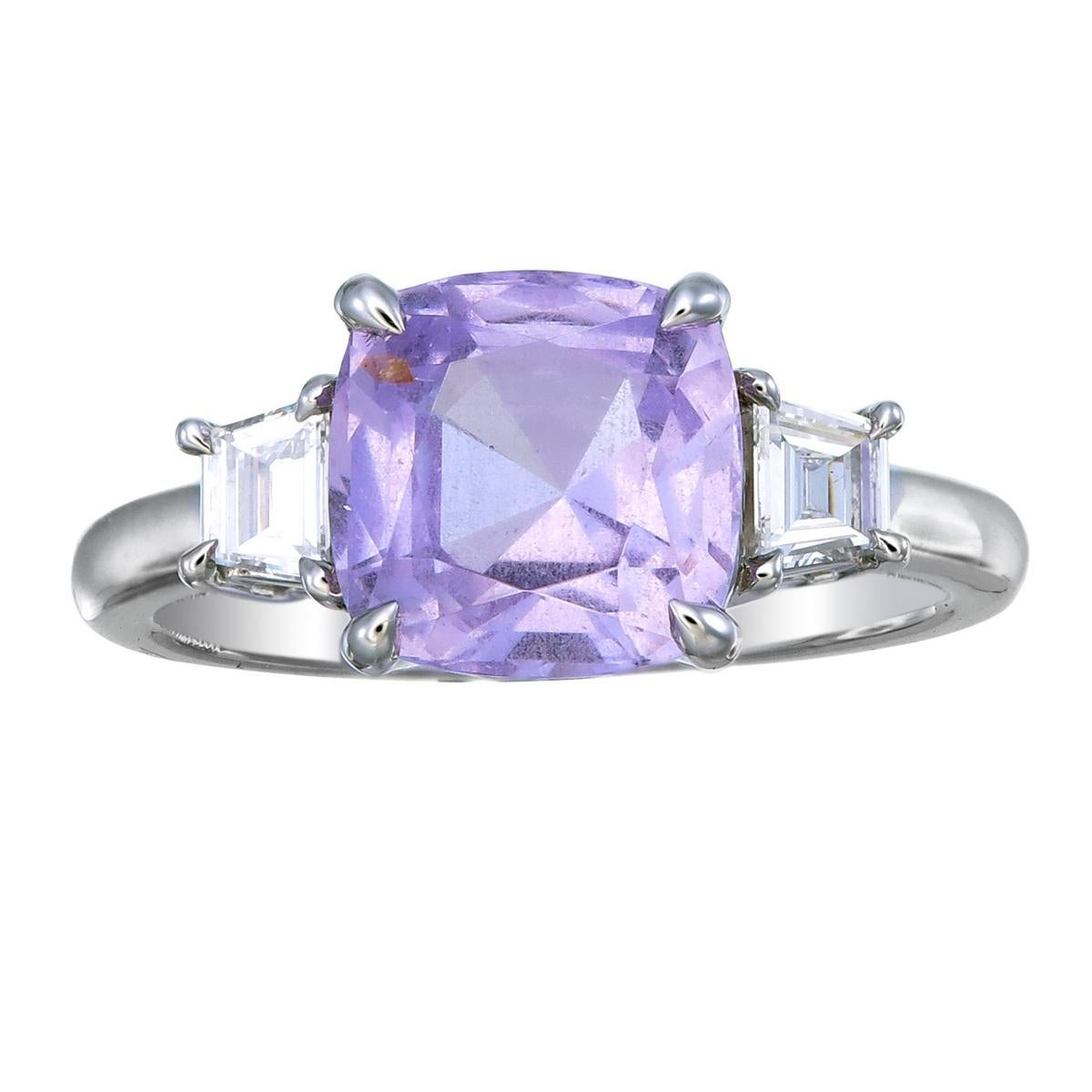 Orloff of Denmark's: Luscious Lilac.
This exquisite 950 Platinum Ring showcases a mesmerizing 'Lilac' purple Spinel, radiating a soft, enchanting hue. Flanking this central gem are two dazzling Trapezoid cut diamonds, each boasting VS clarity and a