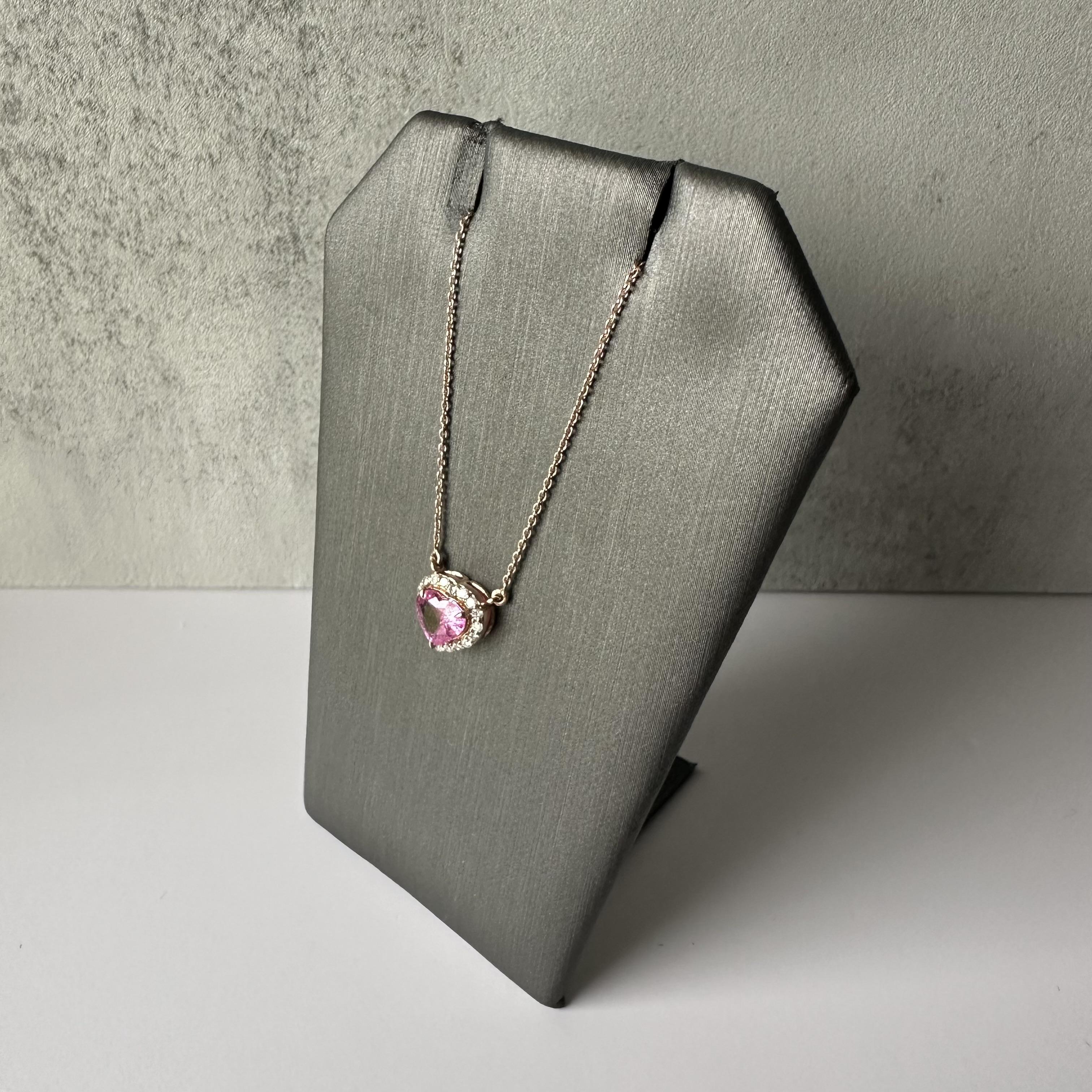 Add a touch of elegance and romance to your jewelry collection with this stunning Pink Sapphire and Diamond Heart Necklace, crafted in luxurious 14kt Rose Gold. This exquisite piece features a brilliant 0.93 carat total weight (ctw) of vibrant,