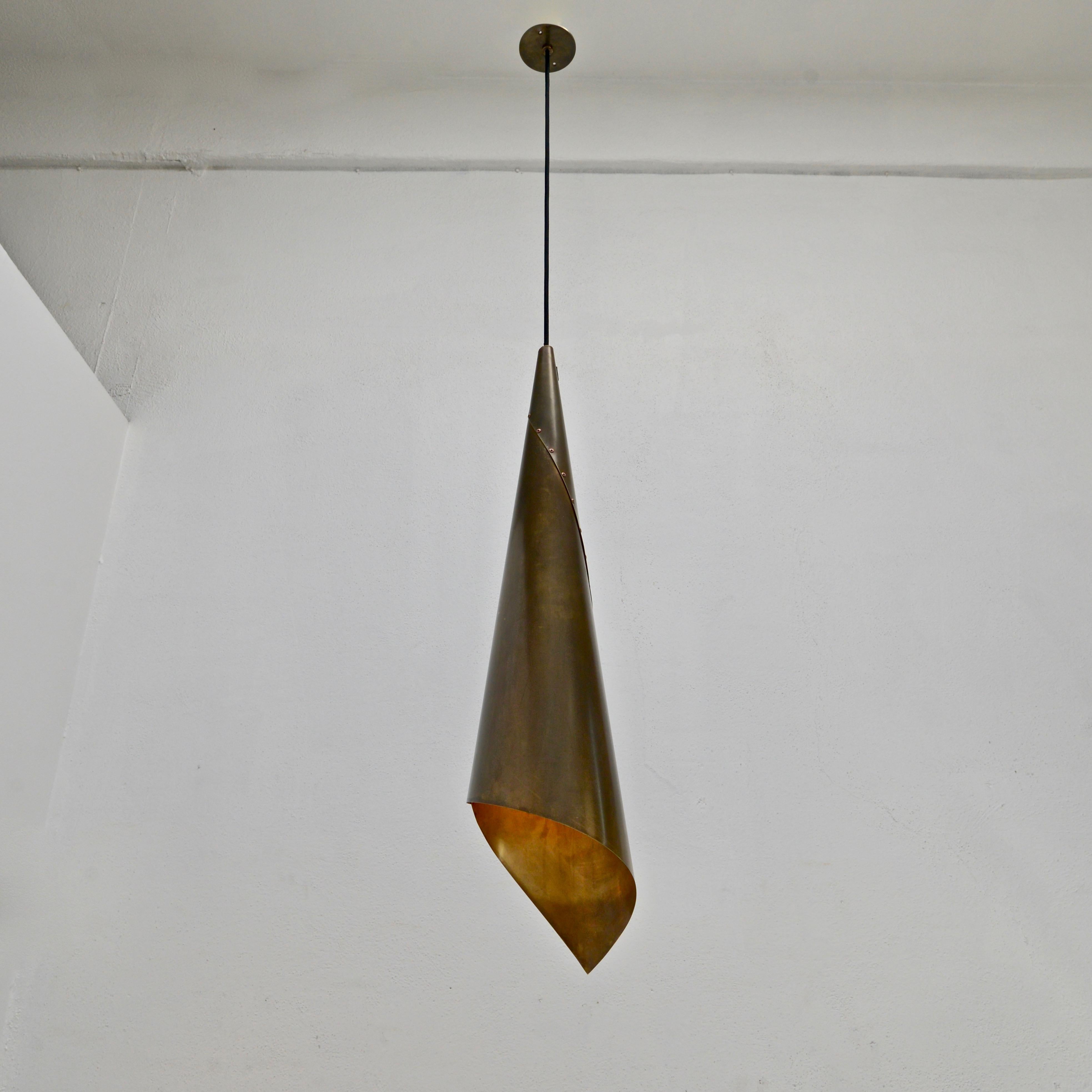 Rustic and raw yet soft and elegant handcrafted pendant by Lumfardo Luminaires. Brass is un-lacquered and naturally patinated. Made to order. Custom finish and OAD can be made upon request. One E26 medium based light socket per shade. Priced