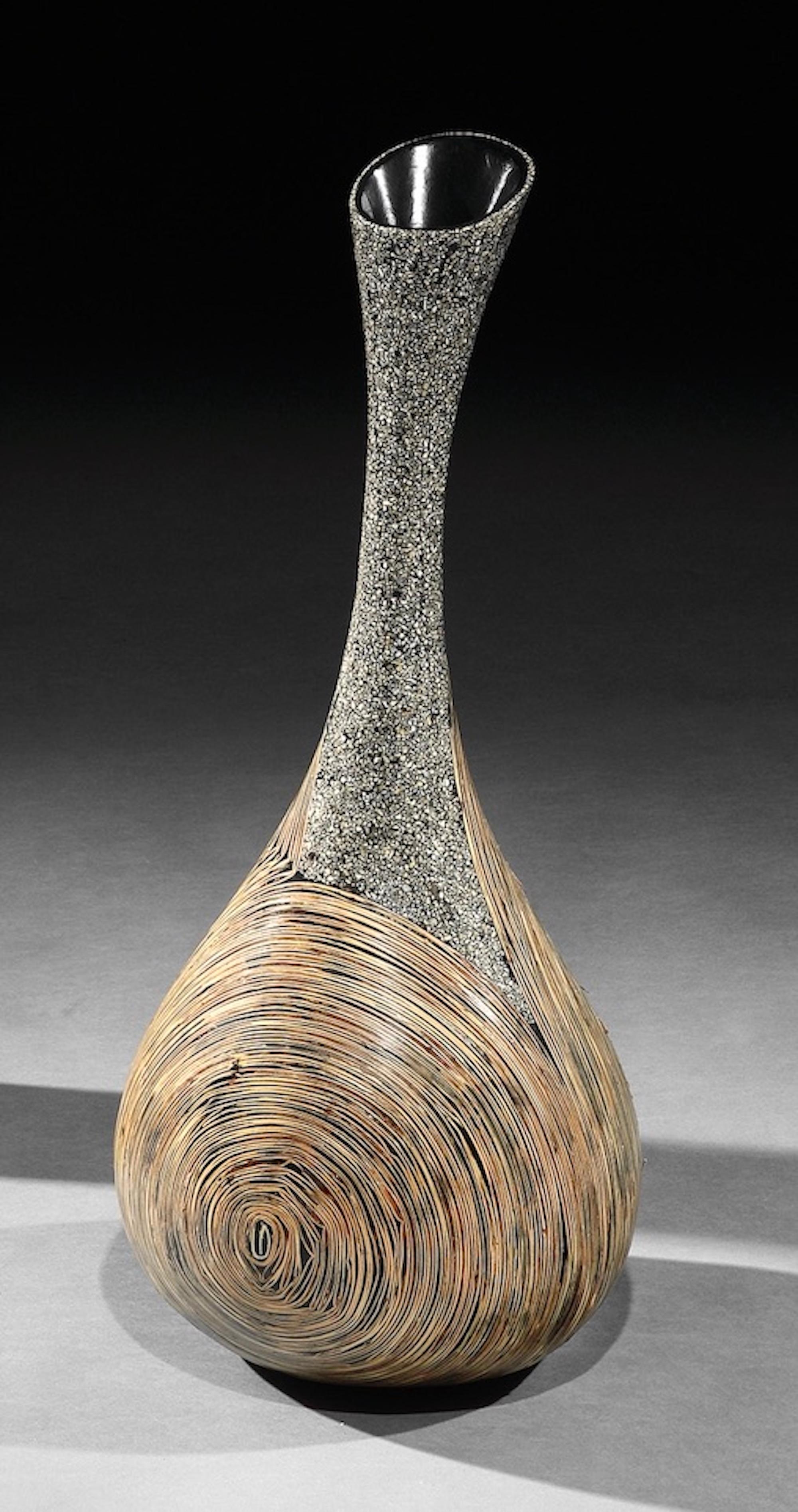 Lusia Robinson: Infinity Vase
This vase is characteristic of Robinson’s work emphasizing materiality within form integrating indigenous materials with modern technology and applications

- The open lip, sweeping neck and round body create a fluid