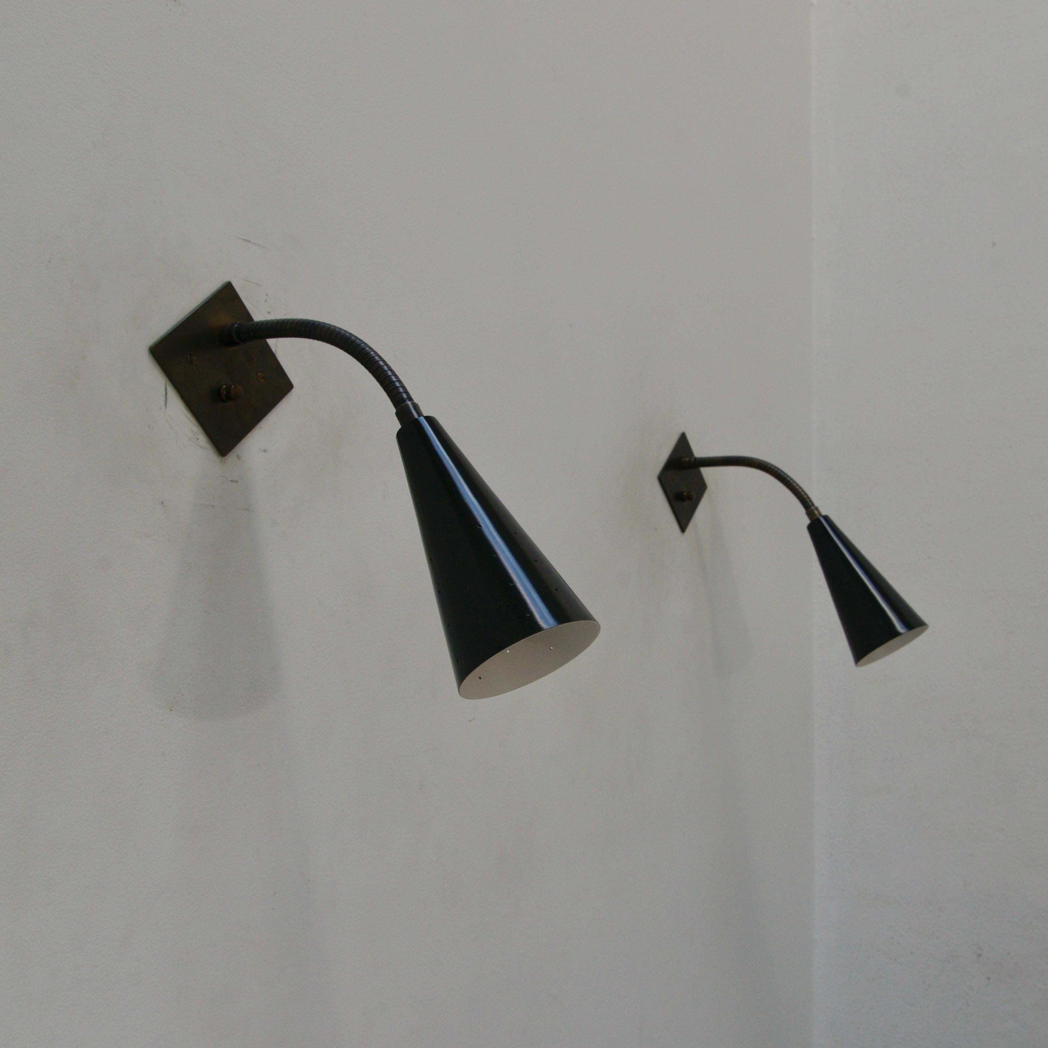 A classic black and brass gooseneck sconce in blackened bronze and painted aluminum. Inspired by 1950s Italian midcentury design, this sconce is ideal for reading areas or a bedside. 1 single E-26 medium based socket. Multiples can be ordered.