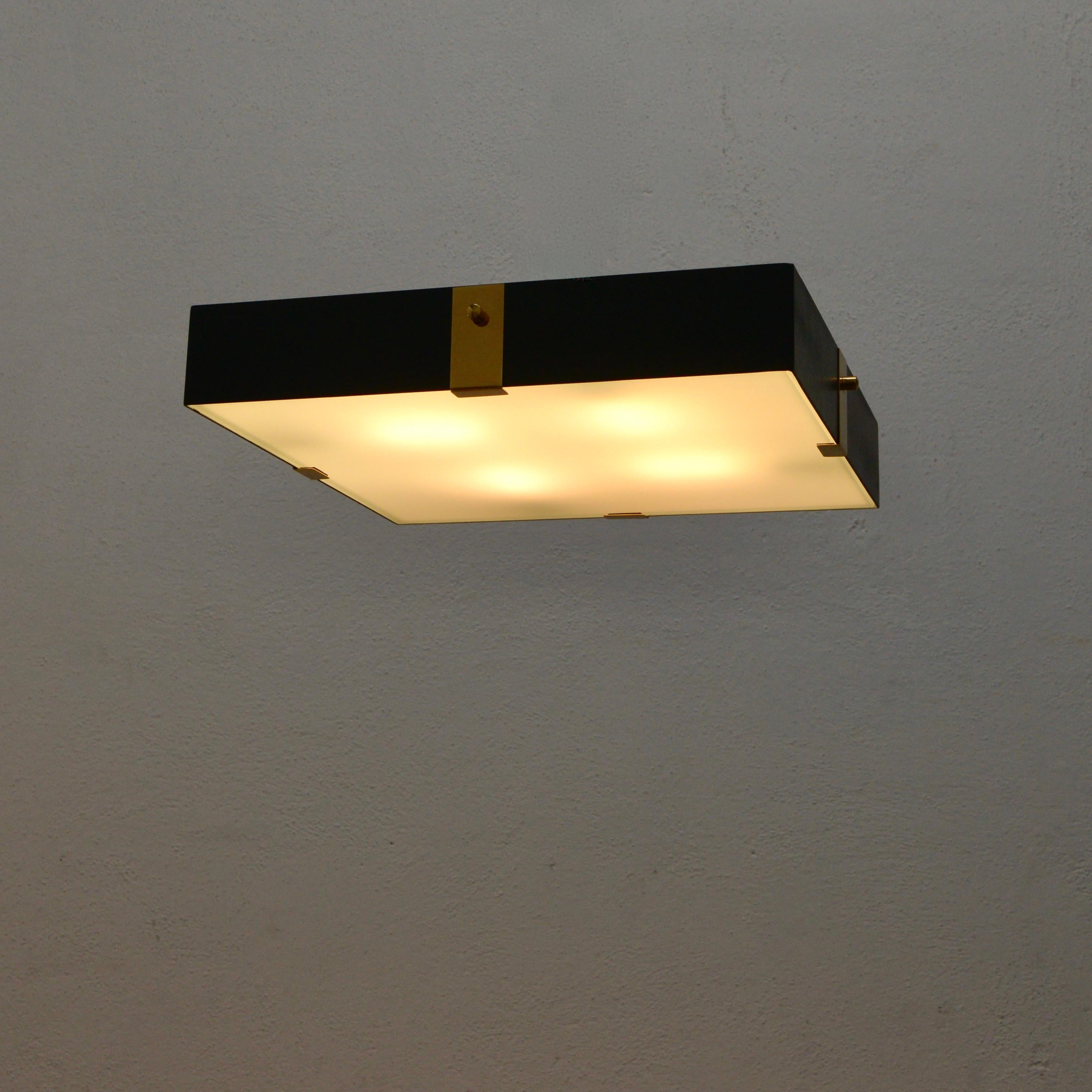 Part of Lumfardo Luminaires contemporary collection, the LUsquare flush mount fixture is made to order. Multiples available. The fixture is made from painted steel, brass and glass. The light is wired with four E26 medium based sockets and can be