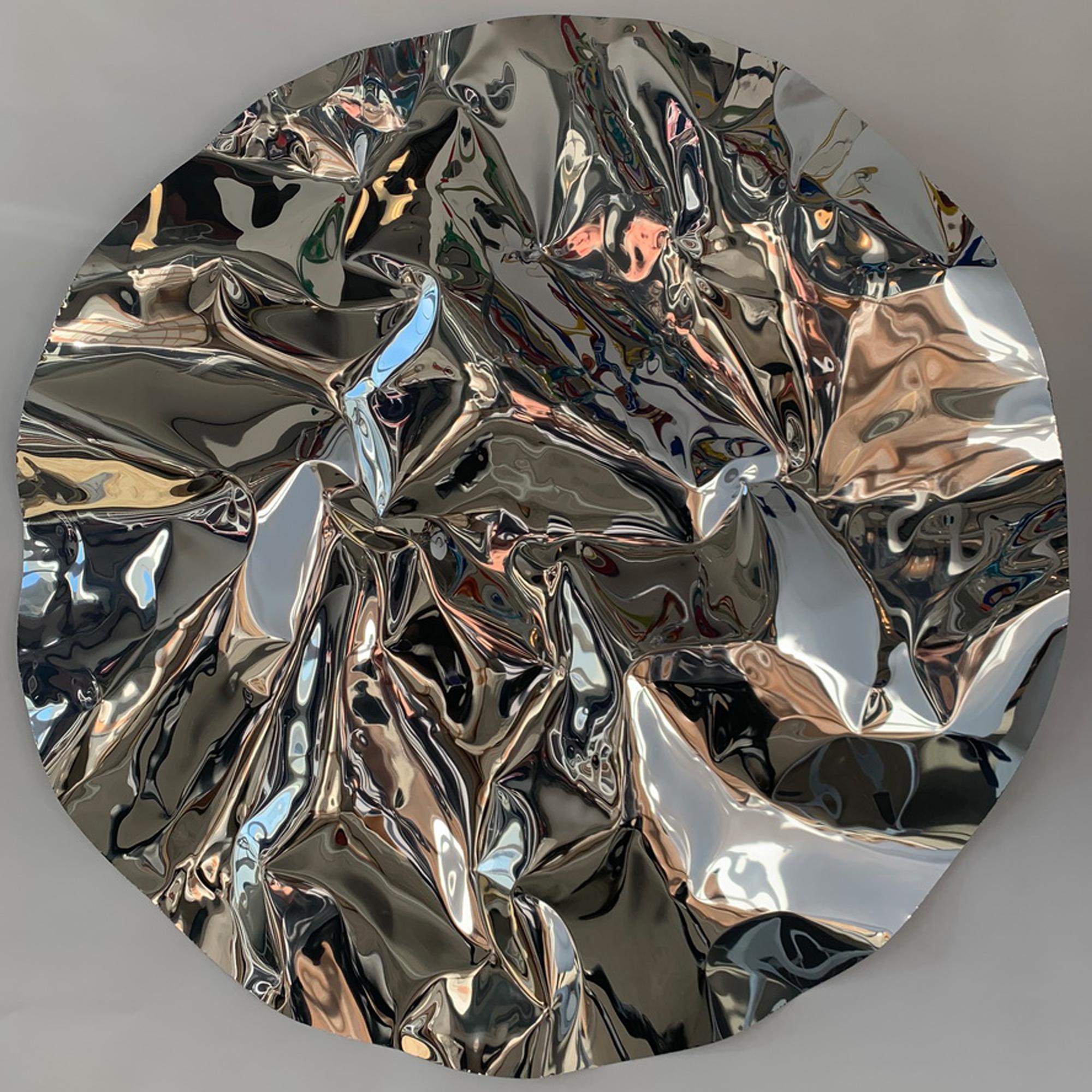 The Luster Medallion is a hand-formed sheet of aluminum, carefully folded and bent to create a ripple effect on the surface. This piece makes a beautiful addition to walls that need texture and visual interest. Mirrored surfaces reflect the interior