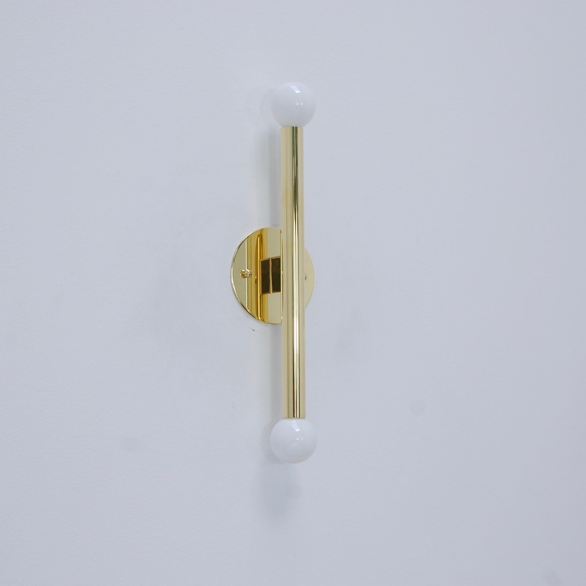 The LUstick sconce is a single brass tubular sconce that is part of our Lumfardo Luminaires contemporary collection. The all brass LUstick sconce is finished in a light patient brass. Inspired by 1950s Italian midcentury design, this sconce can be