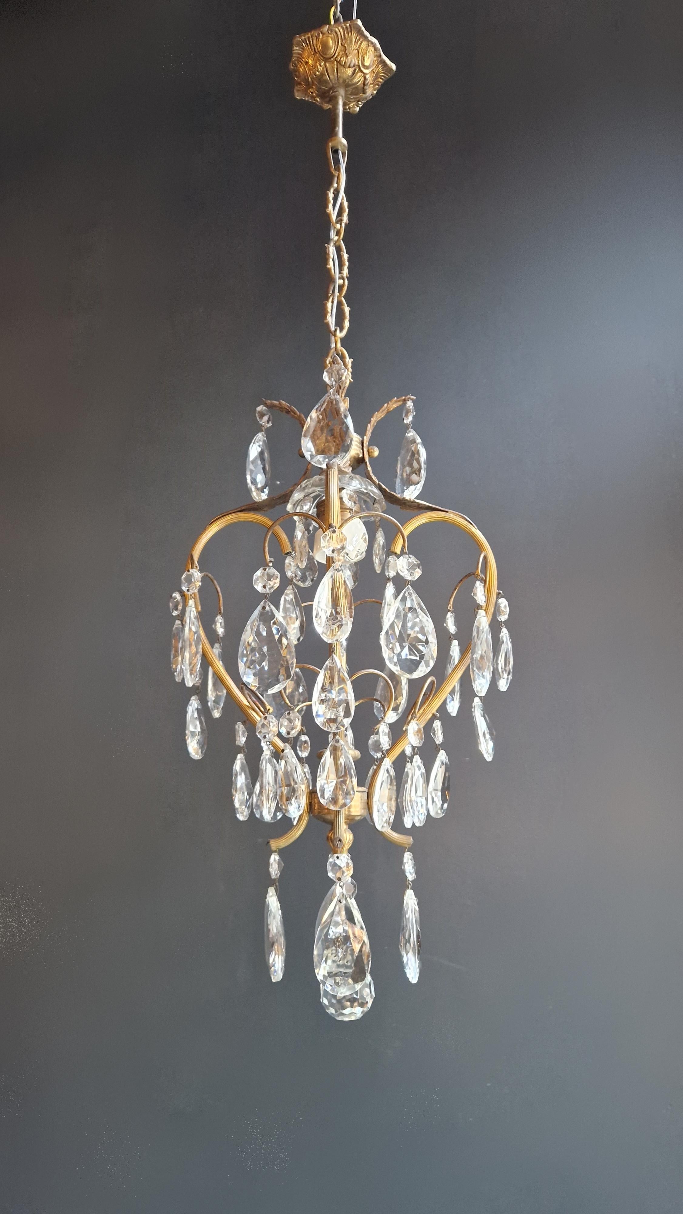 Introducing an exquisitely preserved chandelier from the circa 1940s, meticulously restored to its original glory. The cabling and sockets have been completely renewed, ensuring both safety and functionality. The crystal elements are hand-knotted,