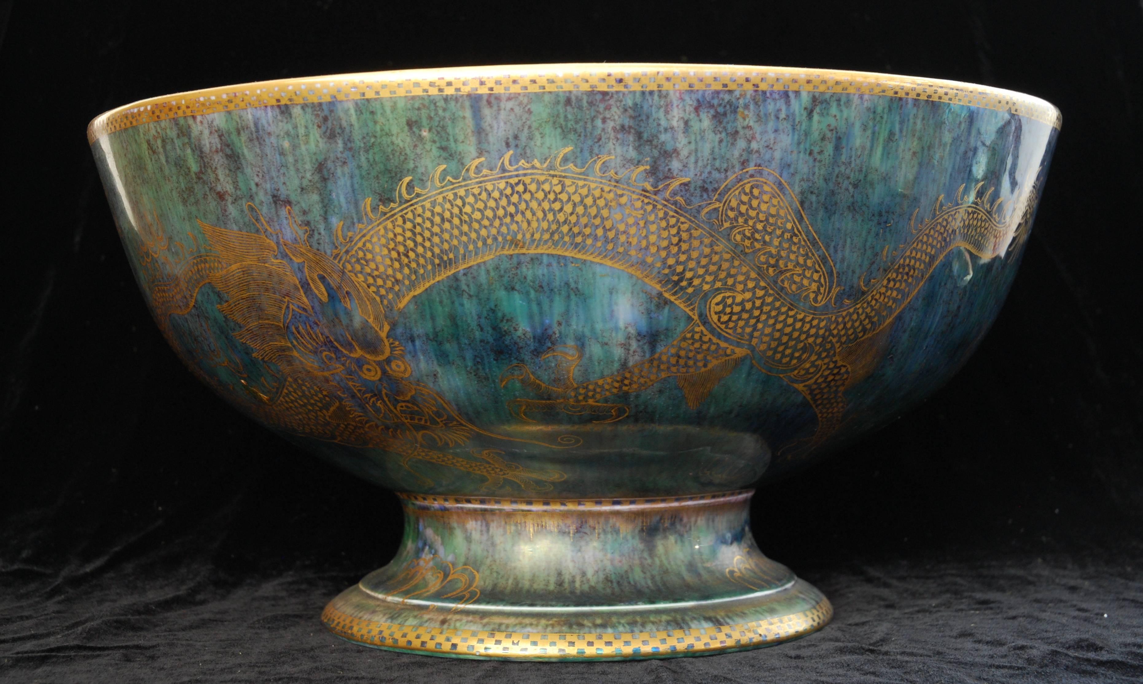 An unusual punch bowl in ‘ordinary’ lustre: blue and green lustres to the exterior; mother-of-pearl to the interior. Celestial dragons in gilt to both.