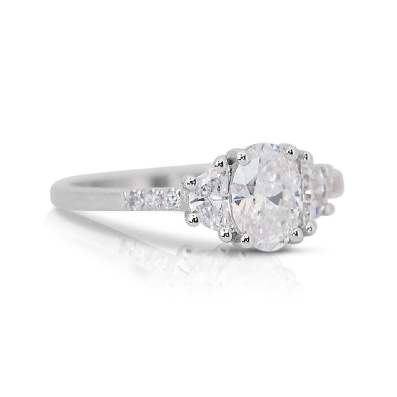 Lustrous 18k White Gold Natural Diamond Pave Ring w/1.04 ct - GIA Certified

This captivating 18k white gold ring features a stunning 0.77 carat oval diamond at its center. The center stone is complemented by shimmering pave-set diamonds, including