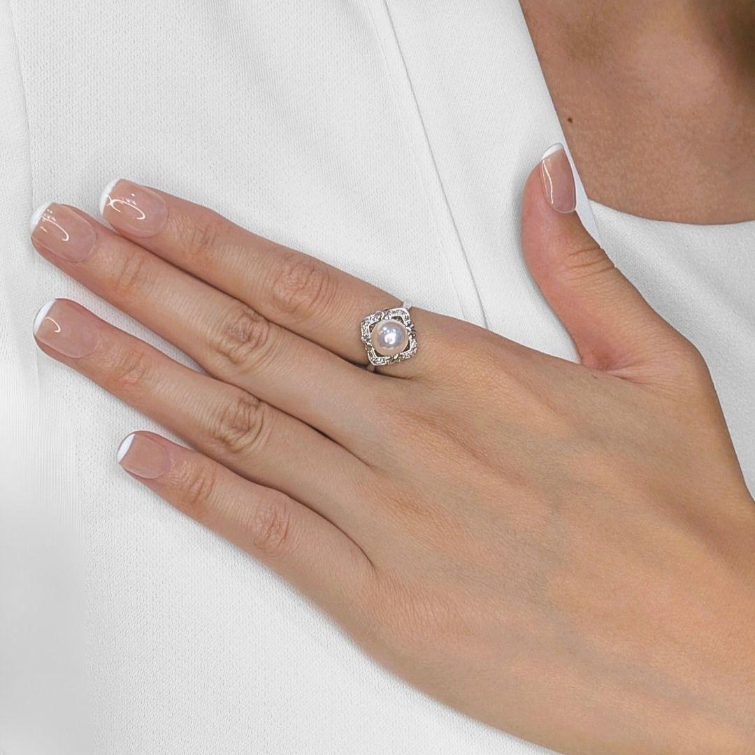 A perfect blend of elegance and sophistication, this newly crafted 18K white gold ring features a luminous 8.2mm Akoya pearl, exuding a delicate pink-white hue, synonymous with timeless beauty. Enhancing its refined aesthetic, 12 round brilliant-cut