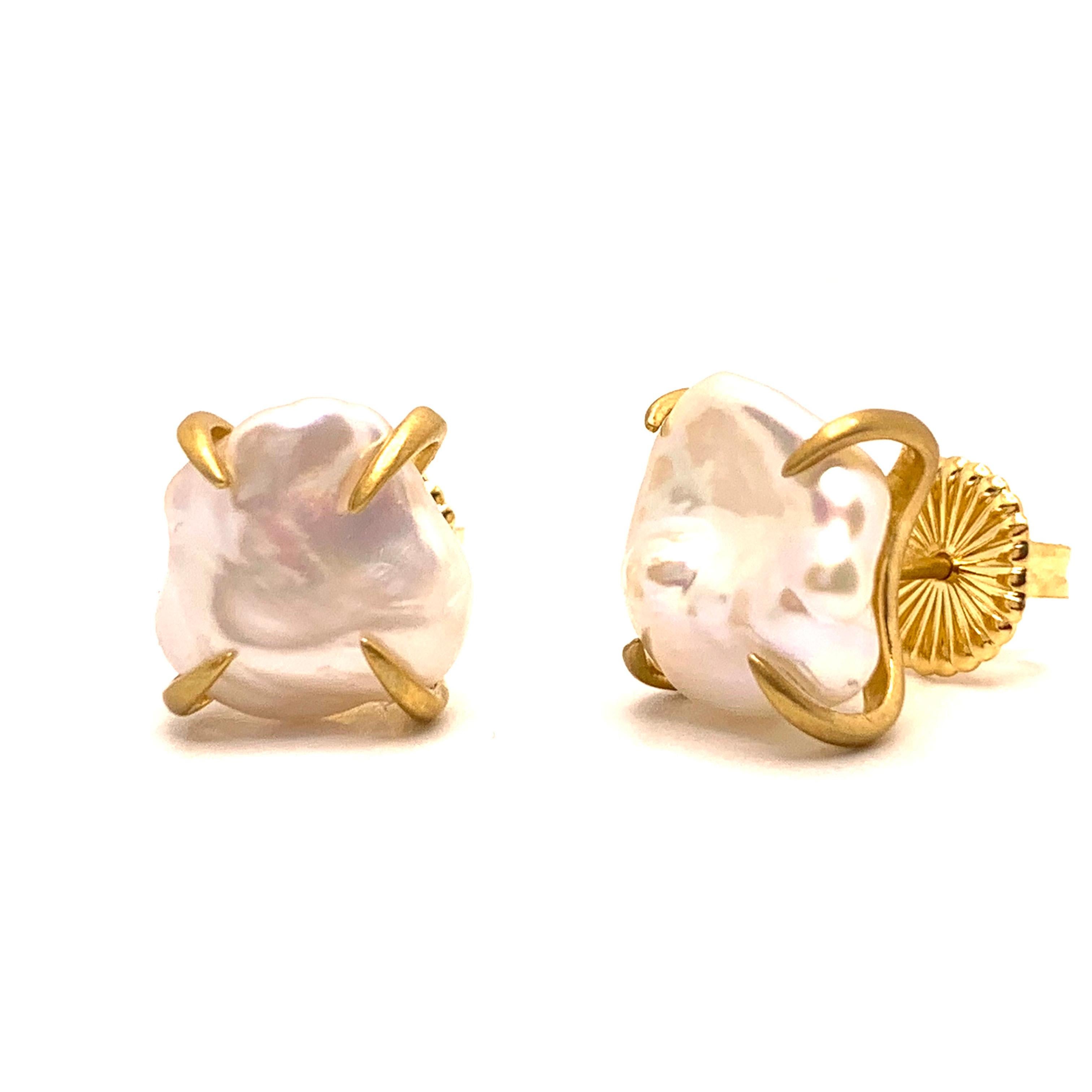 Beautiful pair of lustrous white baroque pearl stud earrings. The pair measures 12-13mm width, handset in 18k yellow gold vermeil over sterling silver (brush satin matte finish). Straight post with large friction back allowing the earrings to sit