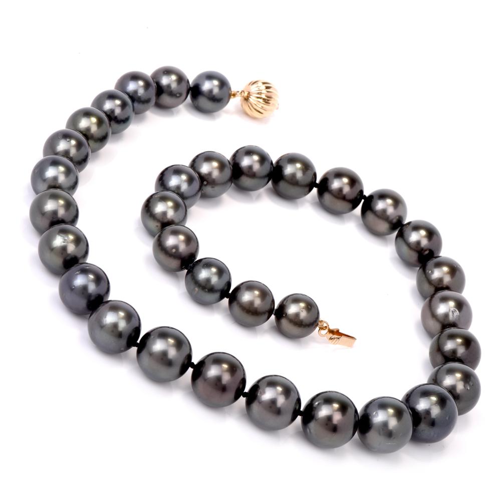 This classically distinct and timelessly elegant Tahitian pearl necklace incorporates 33 highly lustrous, graduated South Sea Tahitian pearls of an exotic Peacock green-black color. The eye-catching 'black pearls' as they are often referred to,