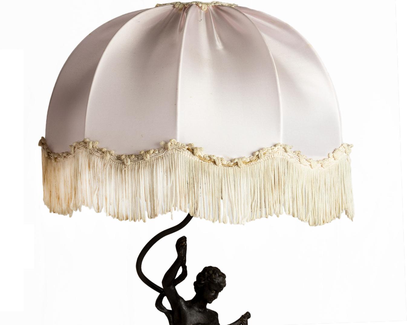 A 19th Century Neoclassical  table lamp with “Musique” description with a dome brocade silk lampshade.
A lady playing the lute and a young child (putti) playing the tambourine

Height 25,59 in (65 cm) 
Diameter 13,77 in (35 com) 
