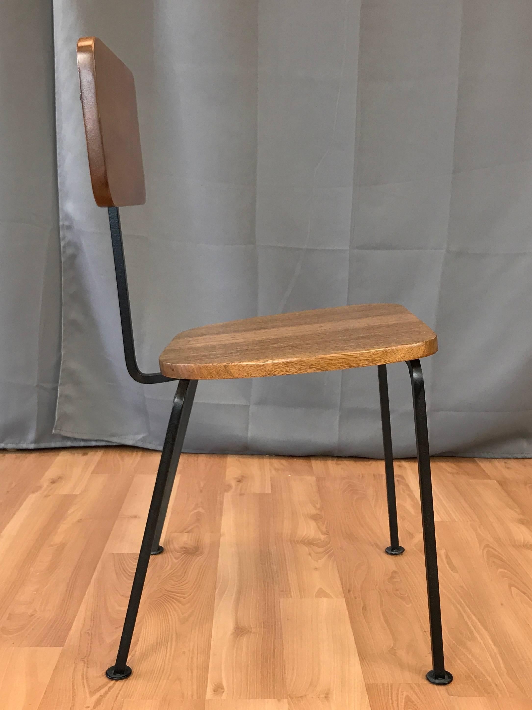 An uncommon Mid-Century Modern side chair in mahogany and enameled steel by Luther Conover.

The side chair expertly distilled to its bare essence, with a minimal form that exudes maximal charm. Solid mahogany seat and back with heavily ticked