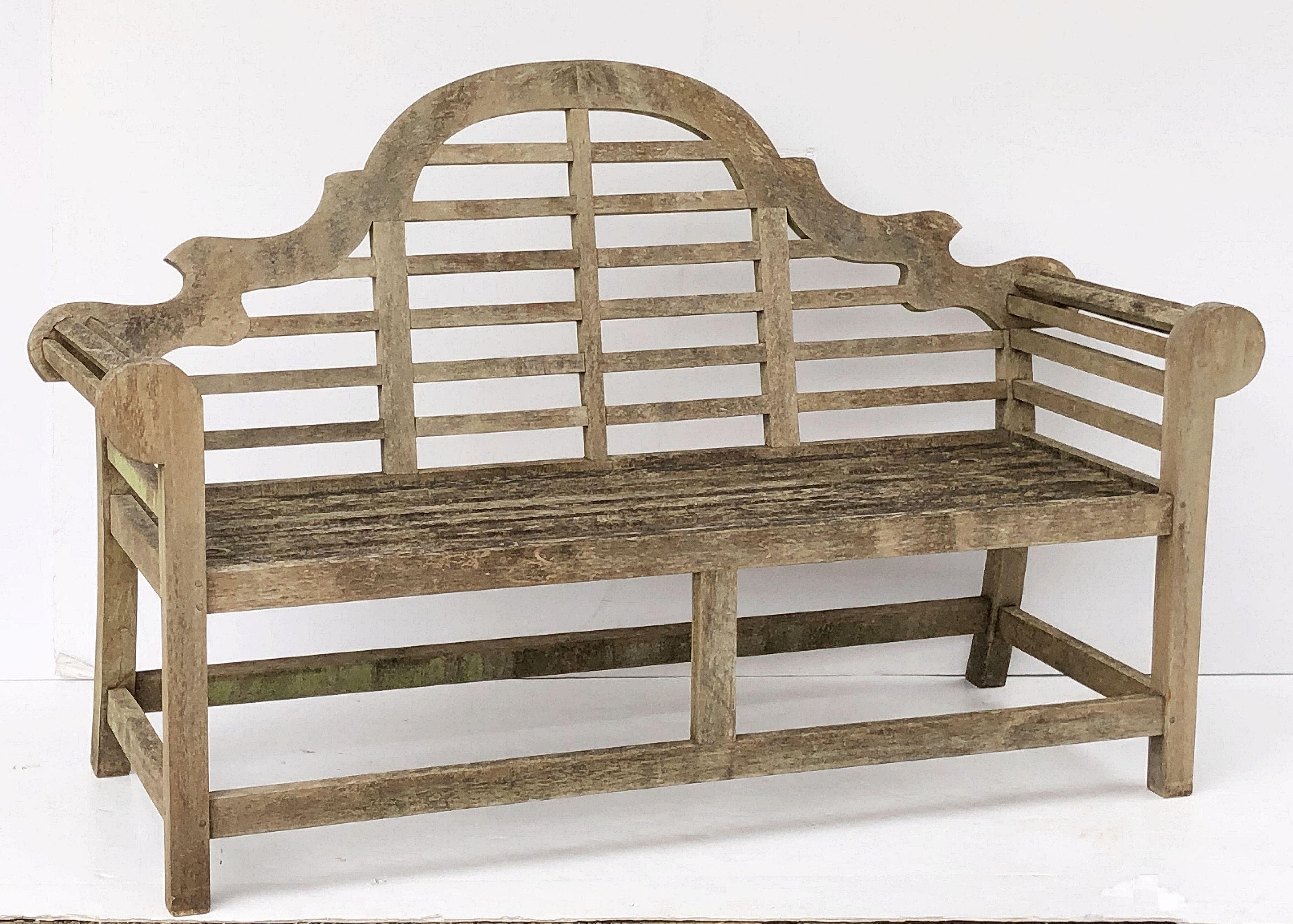 A fine vintage Lutyens style teak English garden bench after Sir Edwin Lutyens, the British architect renowned for his imaginative, Classic designs throughout England, Ireland and New Delhi (India).

Featuring a high-arched back for comfort and