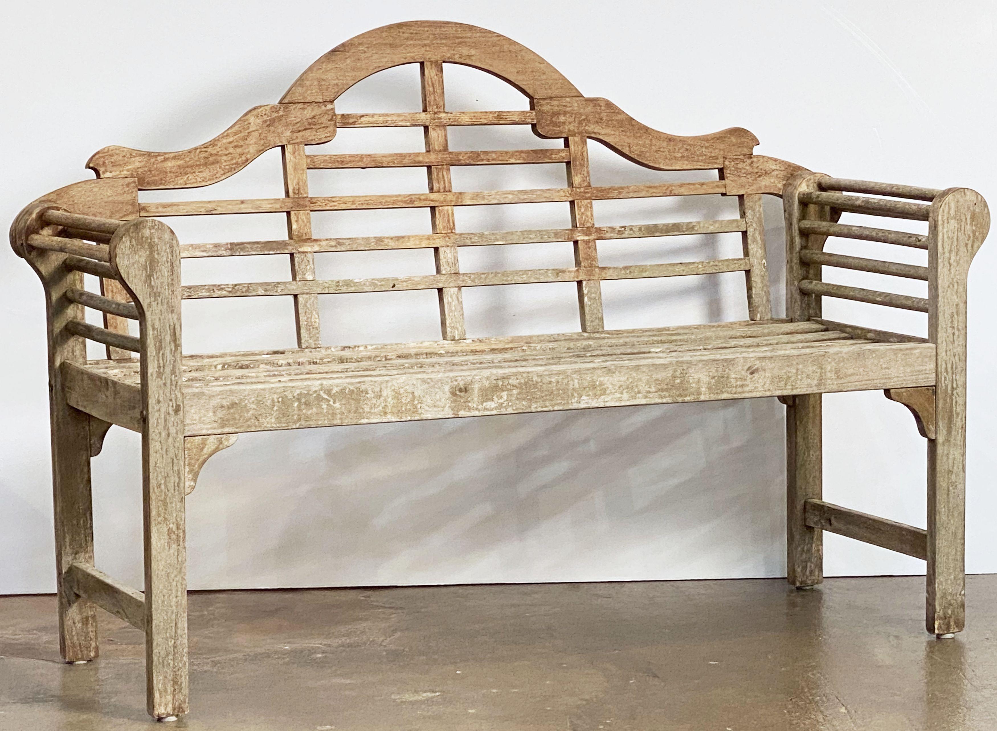 A fine vintage Lutyens style teak English garden bench after Sir Edwin Lutyens, the British architect renowned for his imaginative, classic designs throughout England, Ireland, and New Delhi (India).

Featuring a high-arched back for comfort and