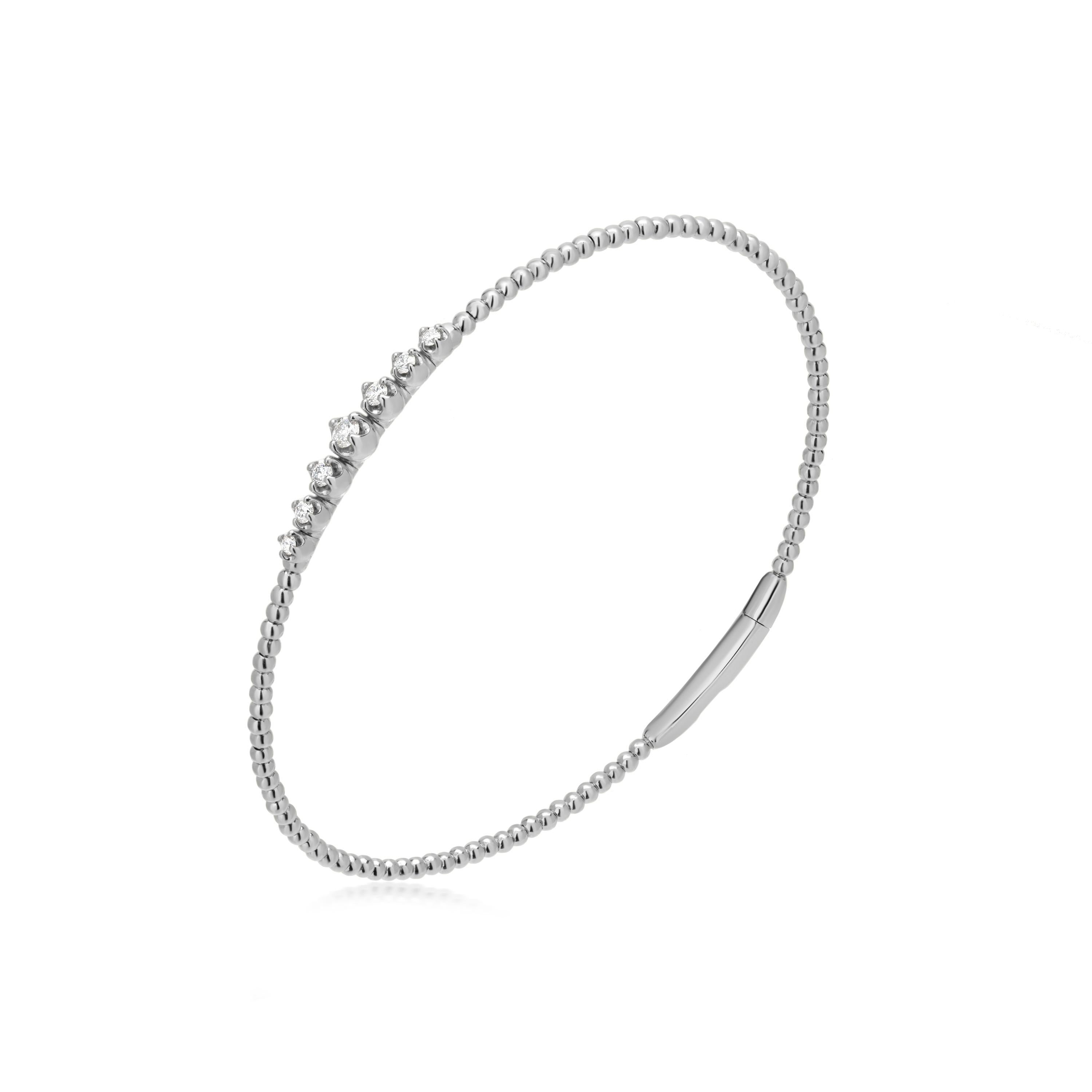 Introducing a stunning Luxle bangle bracelet, crafted with sophisticated style and elegance. This exquisite piece features a graduated diamond setting at its center, where each diamond is prong set to shimmer and shine. The diamonds are round