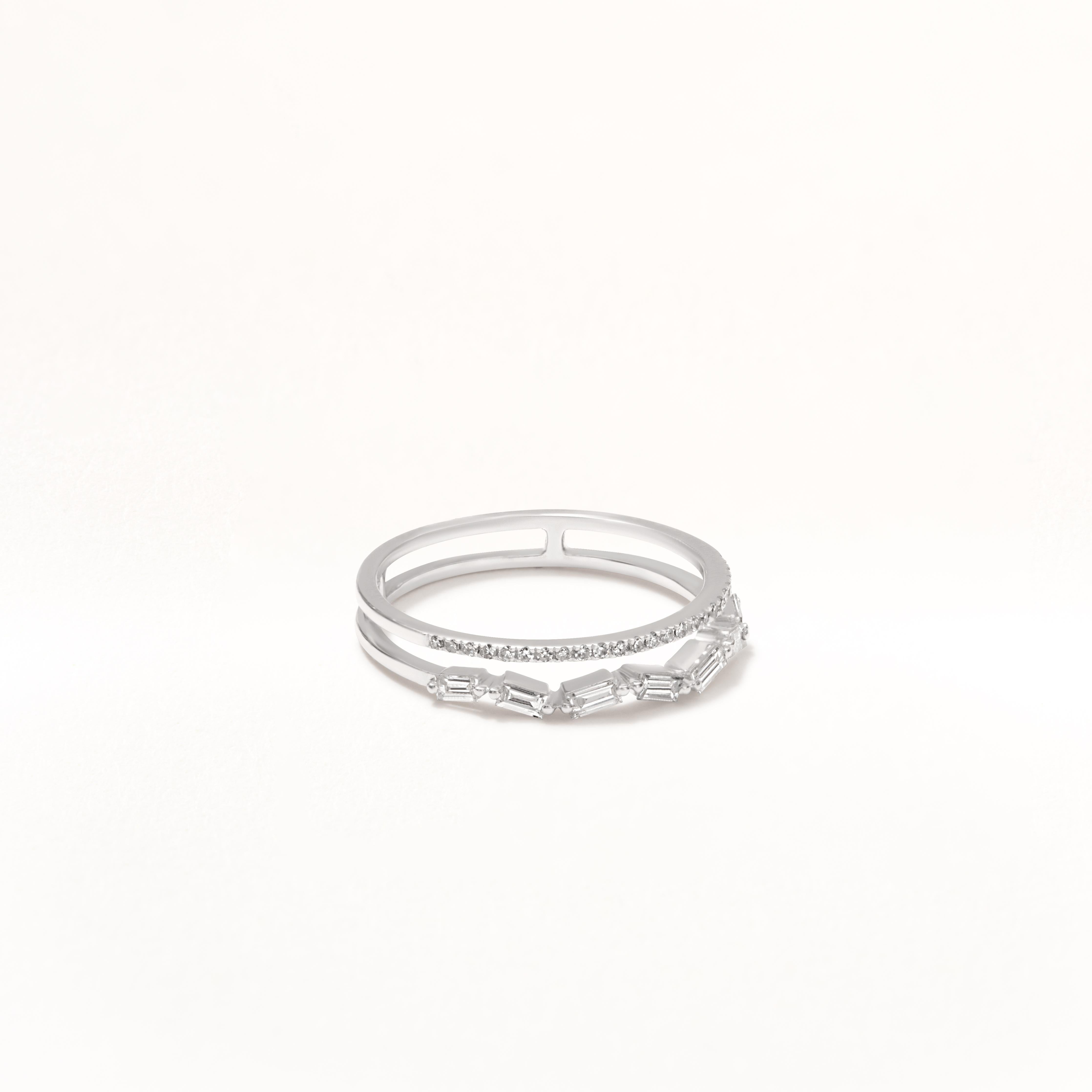 This stylish Luxle diamond 14K white gold ring showcases a double band design. The band is elegantly divided into two separate strands, the outter: has a asystematic baguette cut diamonds set in prongs and inner: has a row of round diamonds