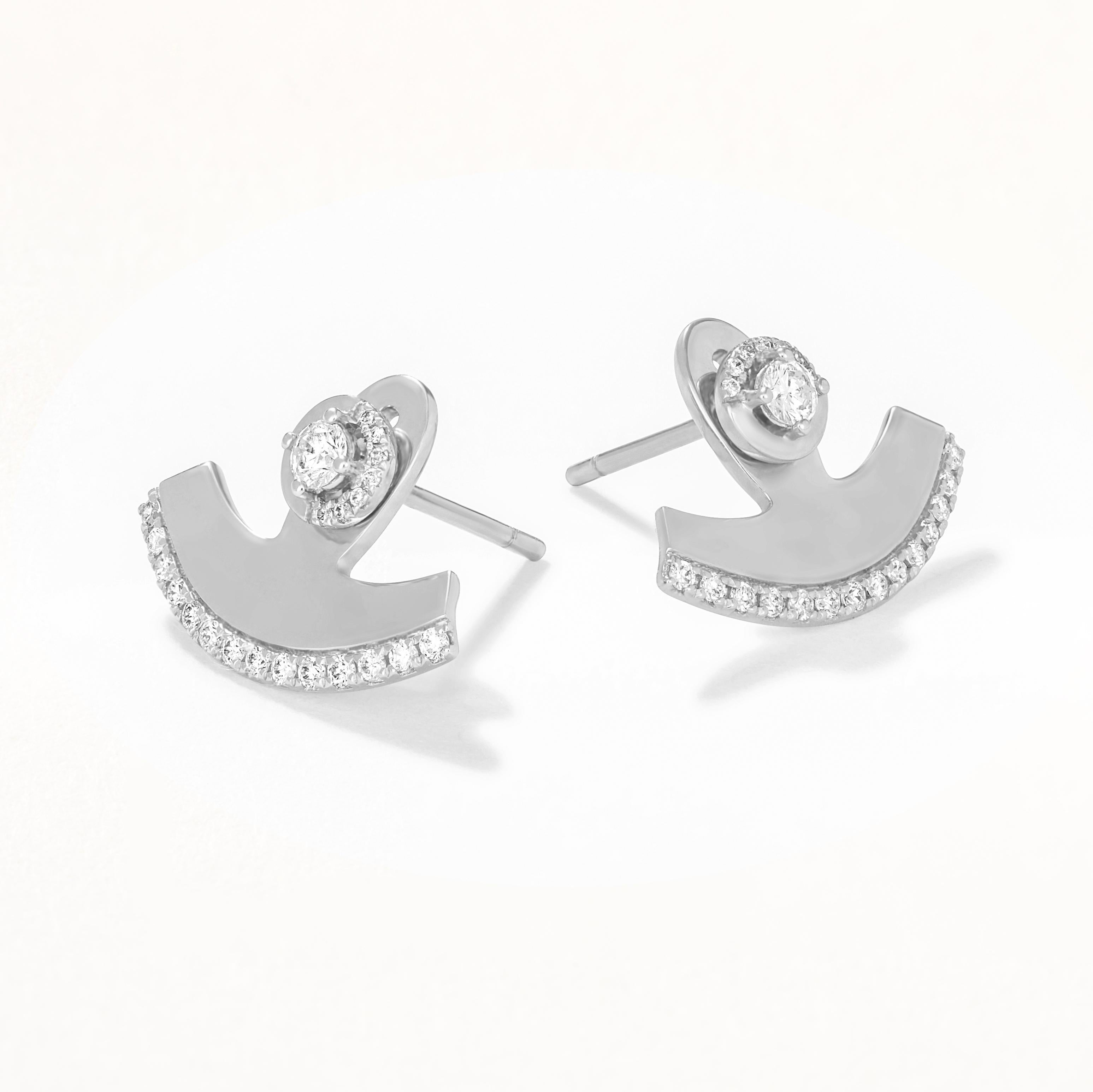 Add a touch of celestial elegance with these Diamond Crescent Stud Earrings. These stunning earrings feature a crescent moon design adorned with shimmering diamonds, creating a striking and unique look. Above the crescent, a round diamond is set in