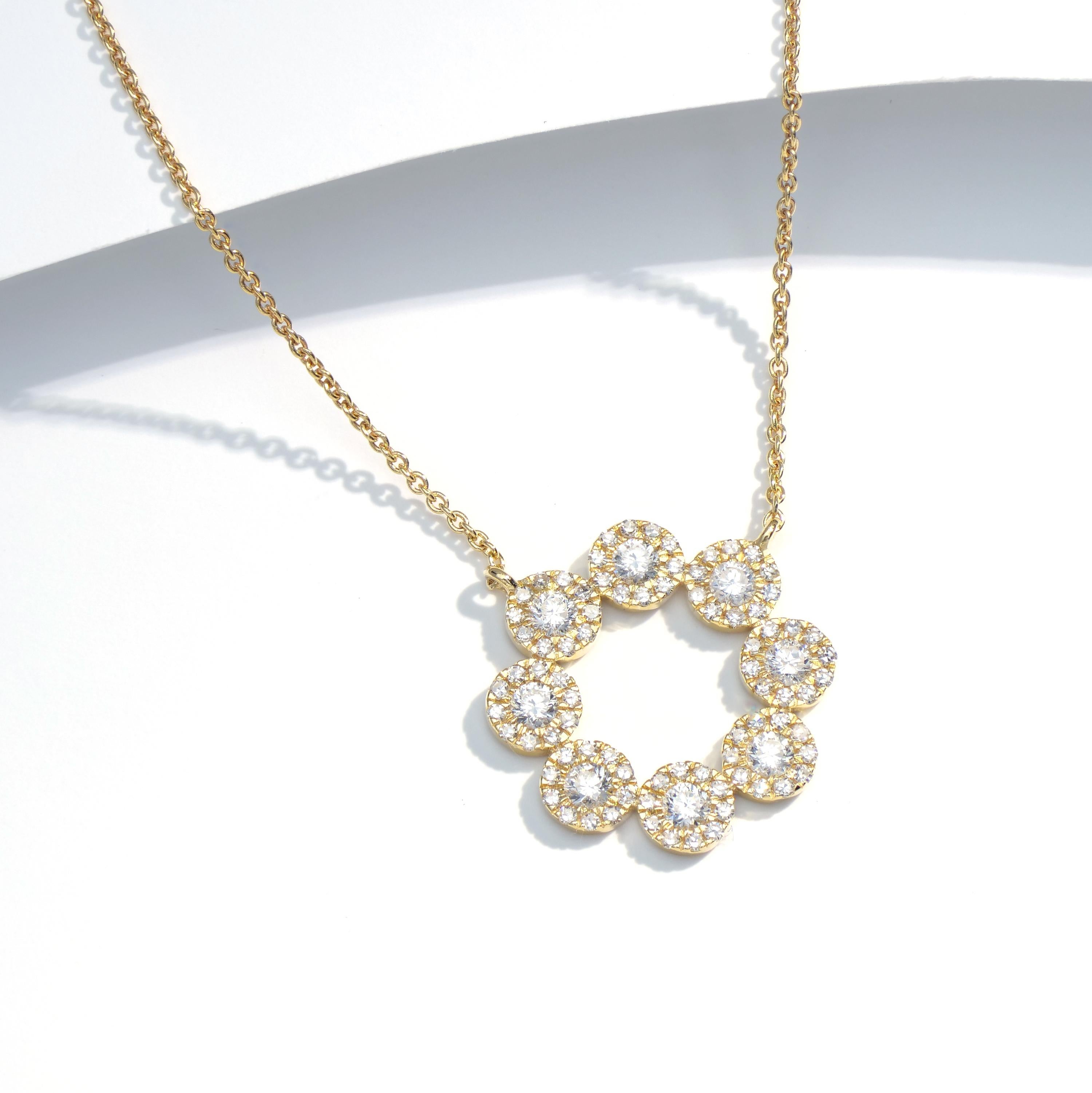 Admiring the simple brilliance of a 14K Yellow Gold Luxle diamond pendant necklace. This necklace features many circle designs that gracefully combine to frame this lovely piece. This pendant hangs from a gold chain and is set with 0.52 carats of