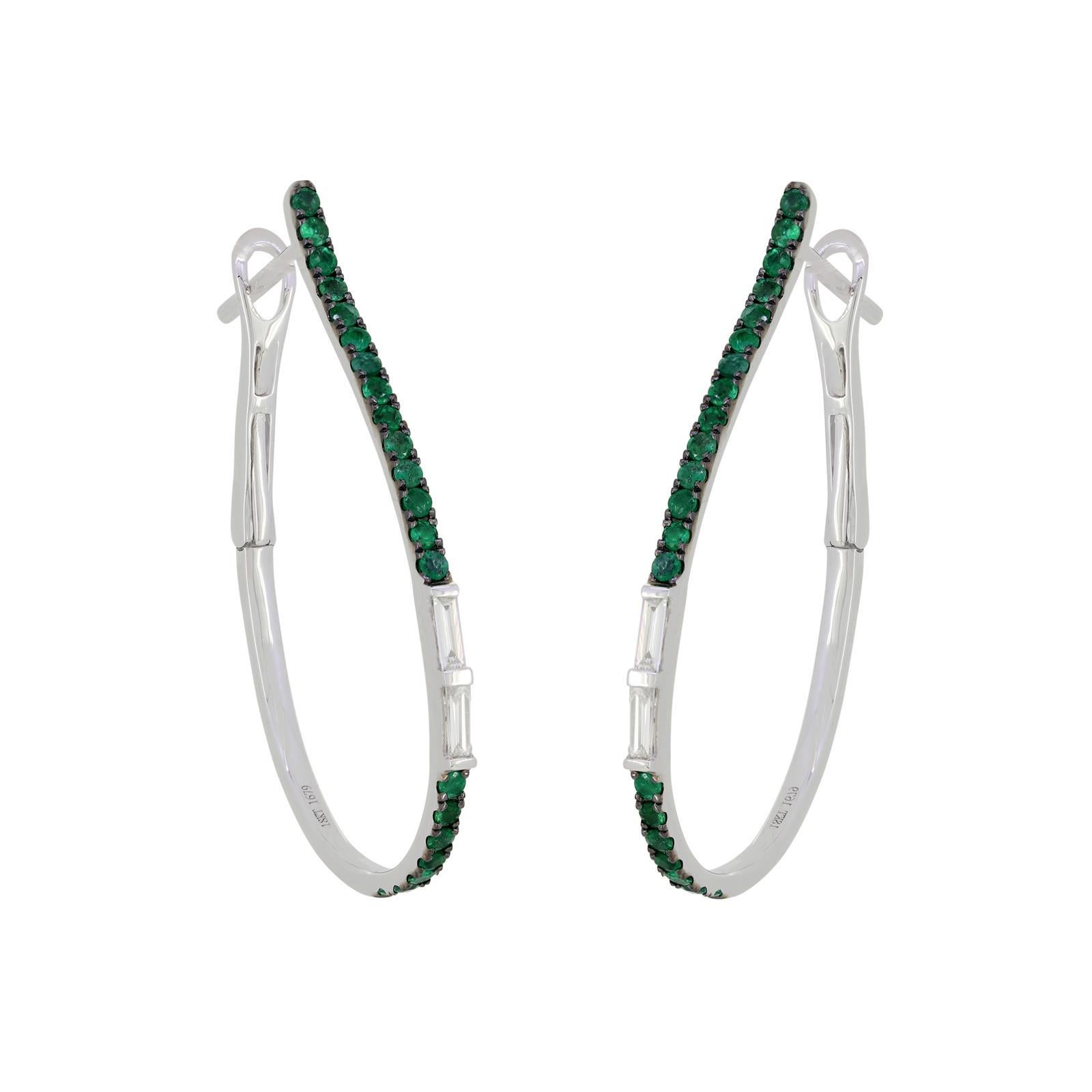 The elegant 14K White Gold Emerald and Diamonds Hoop Earrings blend the timeless allure of hoops. The pear-shaped hoop has a row of emeralds with rich green hues and each individually pronged, the two baguette-cut diamonds with GH color and SI1