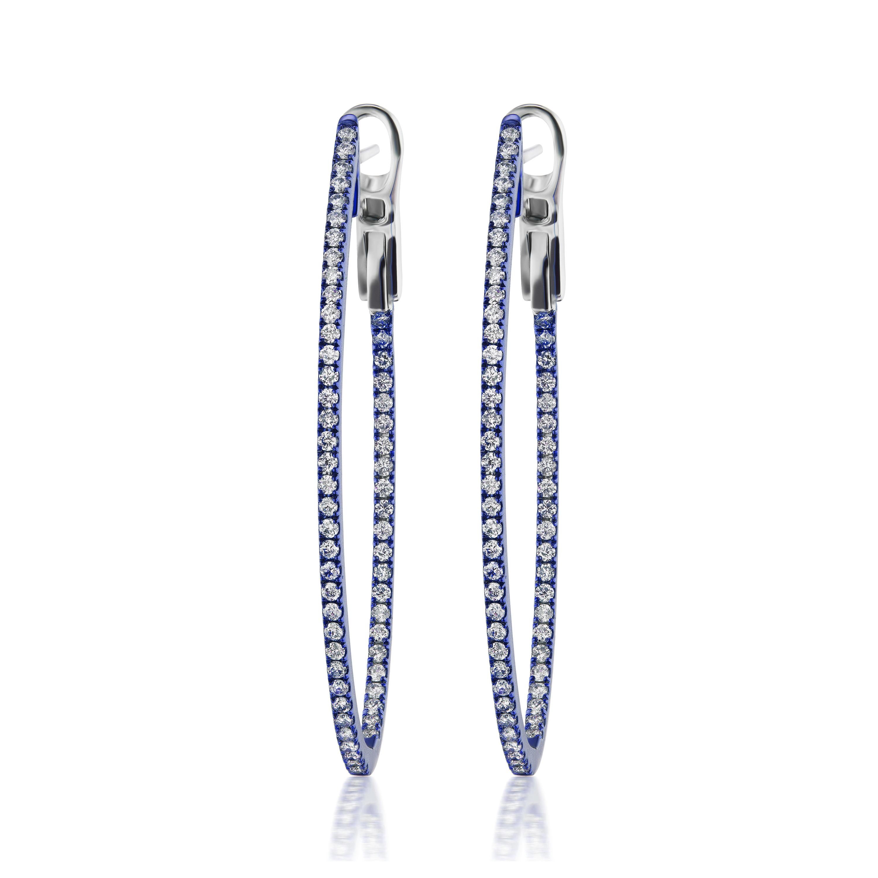 A dazzling pair of hoops featured with 116 pave round diamonds embellished inside and outside. Crafted by Luxle in 18K White gold. The diamonds are I1 in clarity and GH in color, weighing 0.77 Cts. these hoops come with omega backs. The blue rhodium