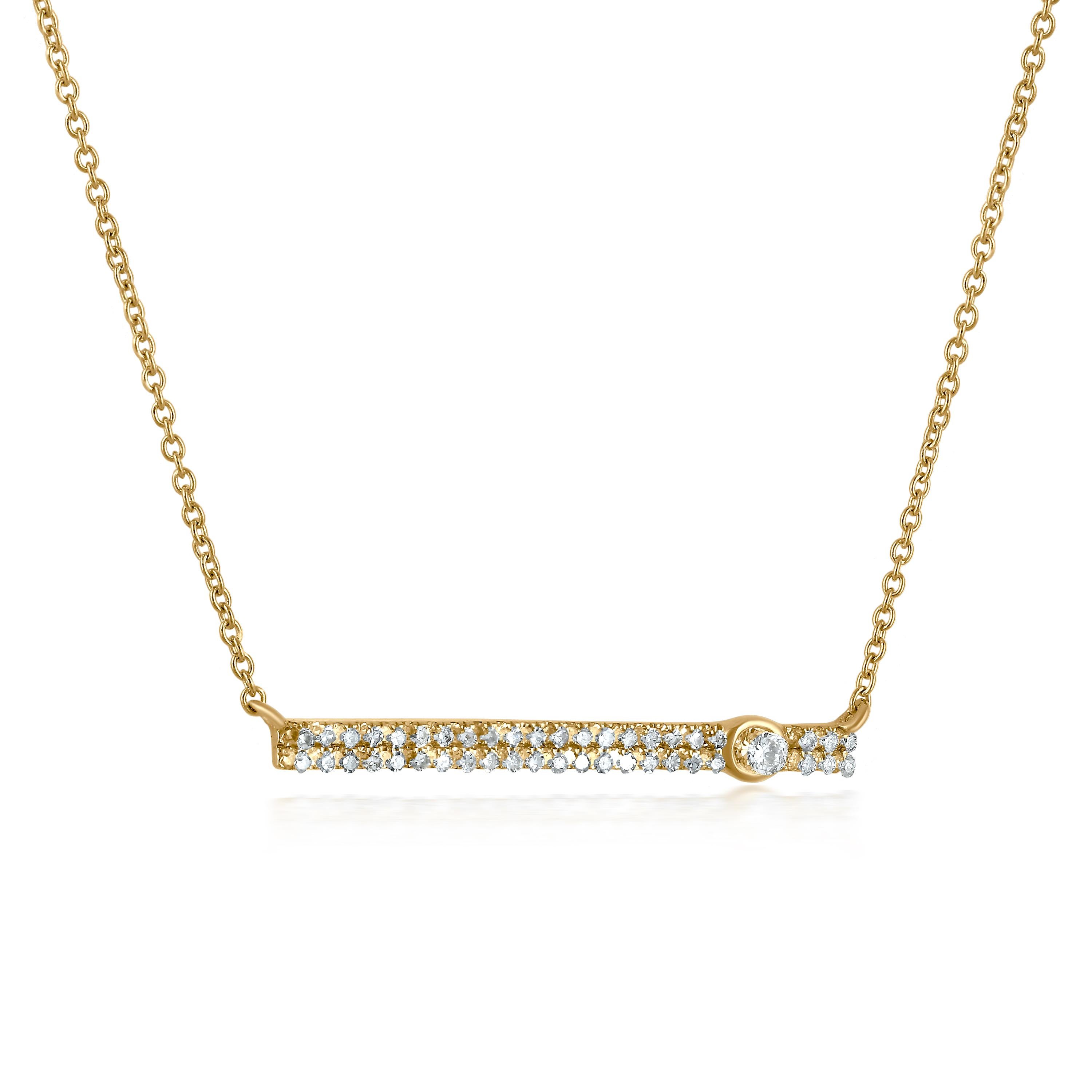 A rectangle bar pendant has two rows of beautifully set 0.21 carat round full-cut and single-cut diamonds. At one end of the bar, a round diamond is bezel set, adding depth to the necklace. This necklace, which hangs from a gold chain, became made