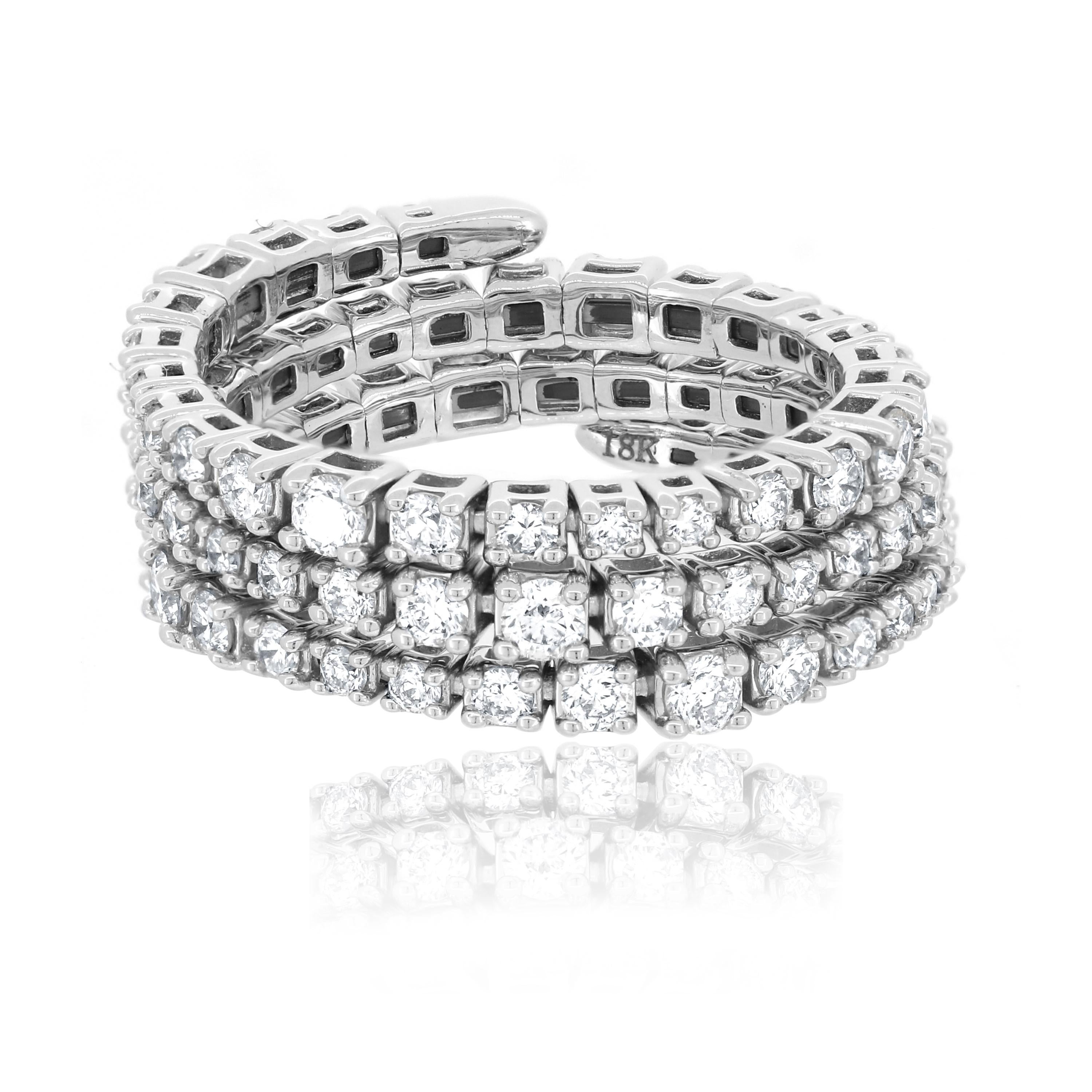 This Luxle diamond spiral ring in 18K white gold shines with an eye-catching sparkle. The three adjacent lines of the ring are lined with 77 round cut glittering diamonds with a color grading of GH and a clarity of I1 set in shared prongs. This
