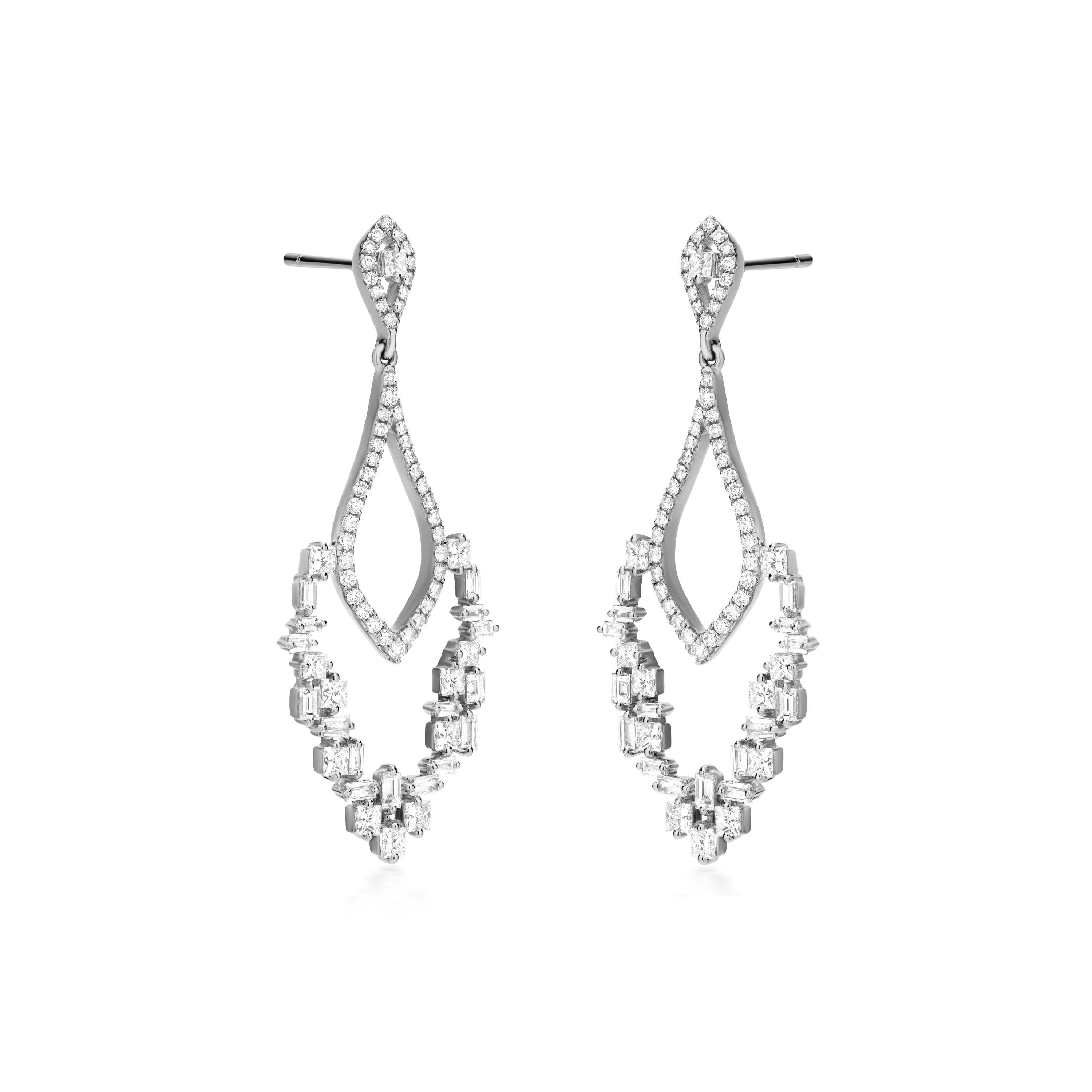 These 18K gold drop earrings are a celebration of contemporary design and exquisite craftsmanship. The teardrop silhouette is reimagined with a dynamic interplay of negative space, creating a striking visual contrast. The carefully selected round