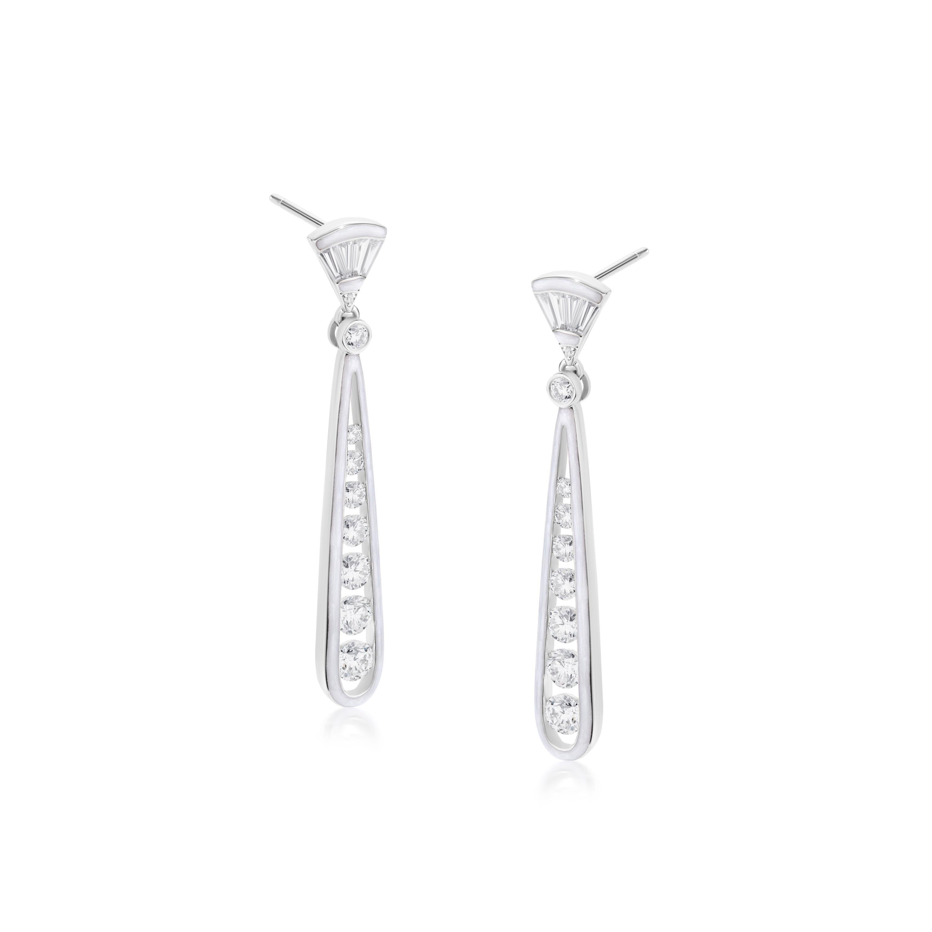 This elongated earring in a drop style is a perfect gift for yourself on your birthday. This stunning pair is crafted on an 18K White Gold body, made by Luxle with round and baguette full-cut white diamonds in tension, bezel, and bar setting. The