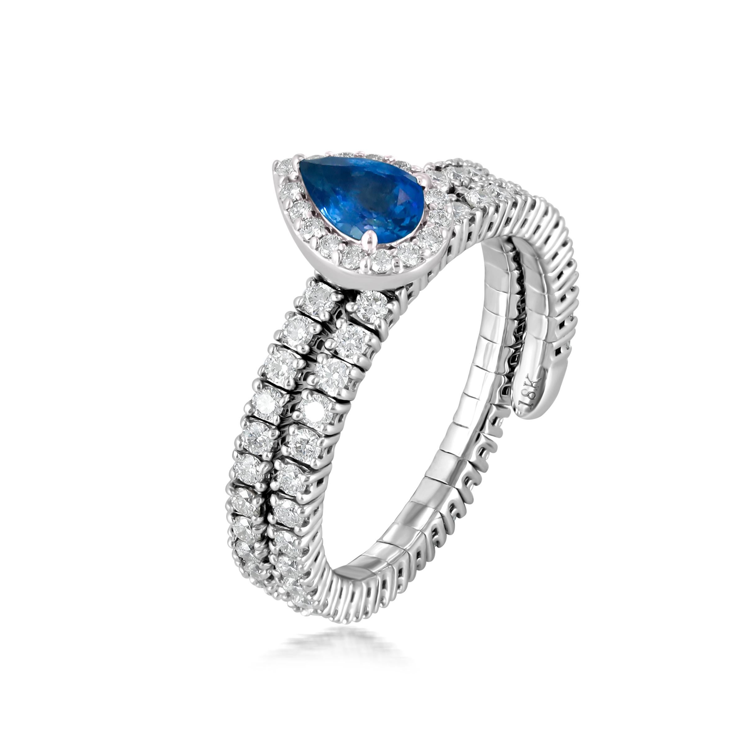Make a statement with this Blue Sapphire and Diamond Snake Ring in 18K White Gold. The ring features a stunning pear-shaped blue sapphire, set in prongs, and surrounded by a halo of round diamonds, also set in prongs. Inspired by the sleek form of a
