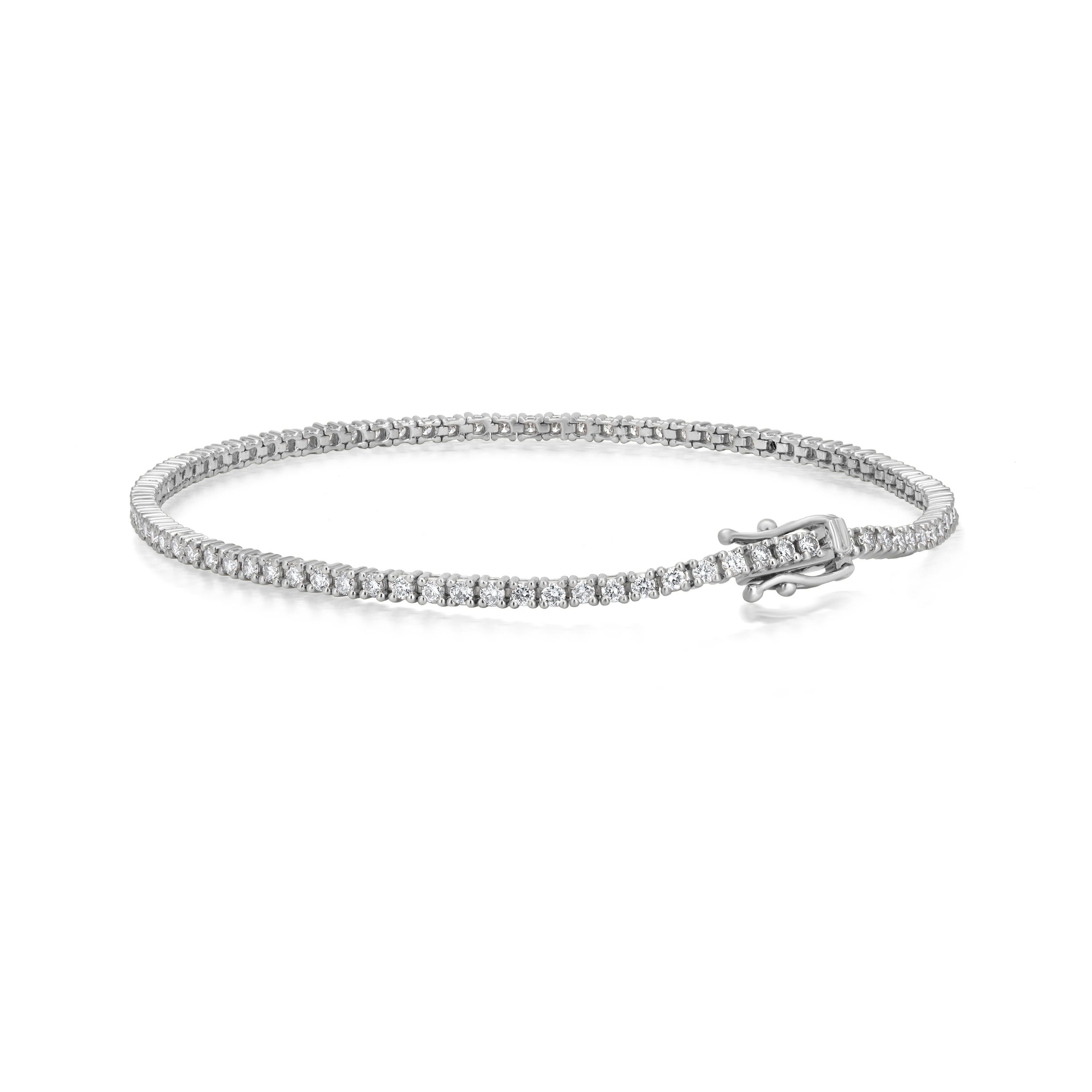 Manifested on an 18K White Gold body, this tennis bracelet is made up of sparkling white diamonds that are round full-cut, set in a prong. The diamonds weigh 1.6 Cts. The diamonds are I1 in clarity and GH in color. This sleek bracelet has an