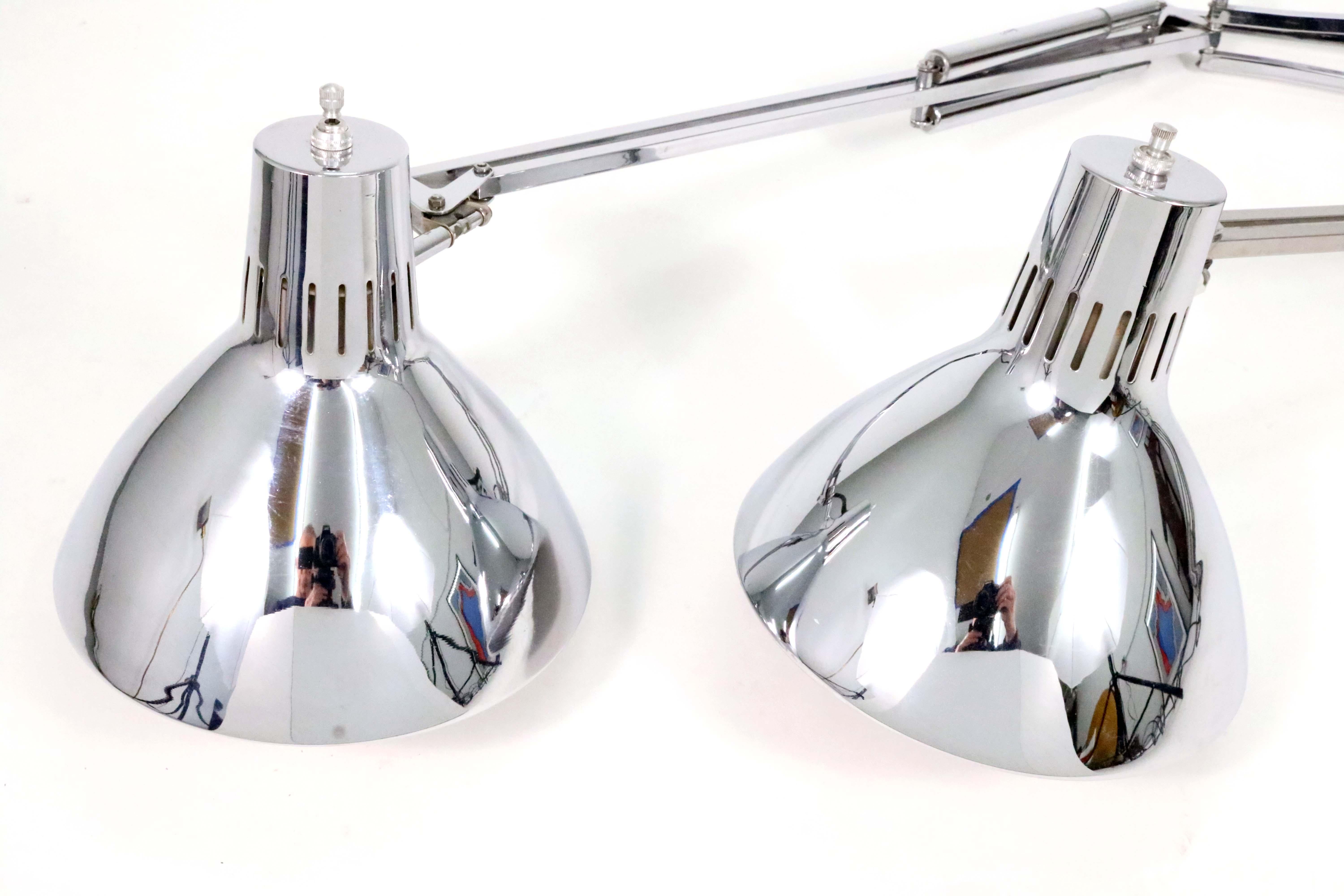 A pair of vintage Luminaire L1 chrome cantilevered desk or task lamps by Jac Jacobsen for Luxo ASA. Norway, 1960s.

