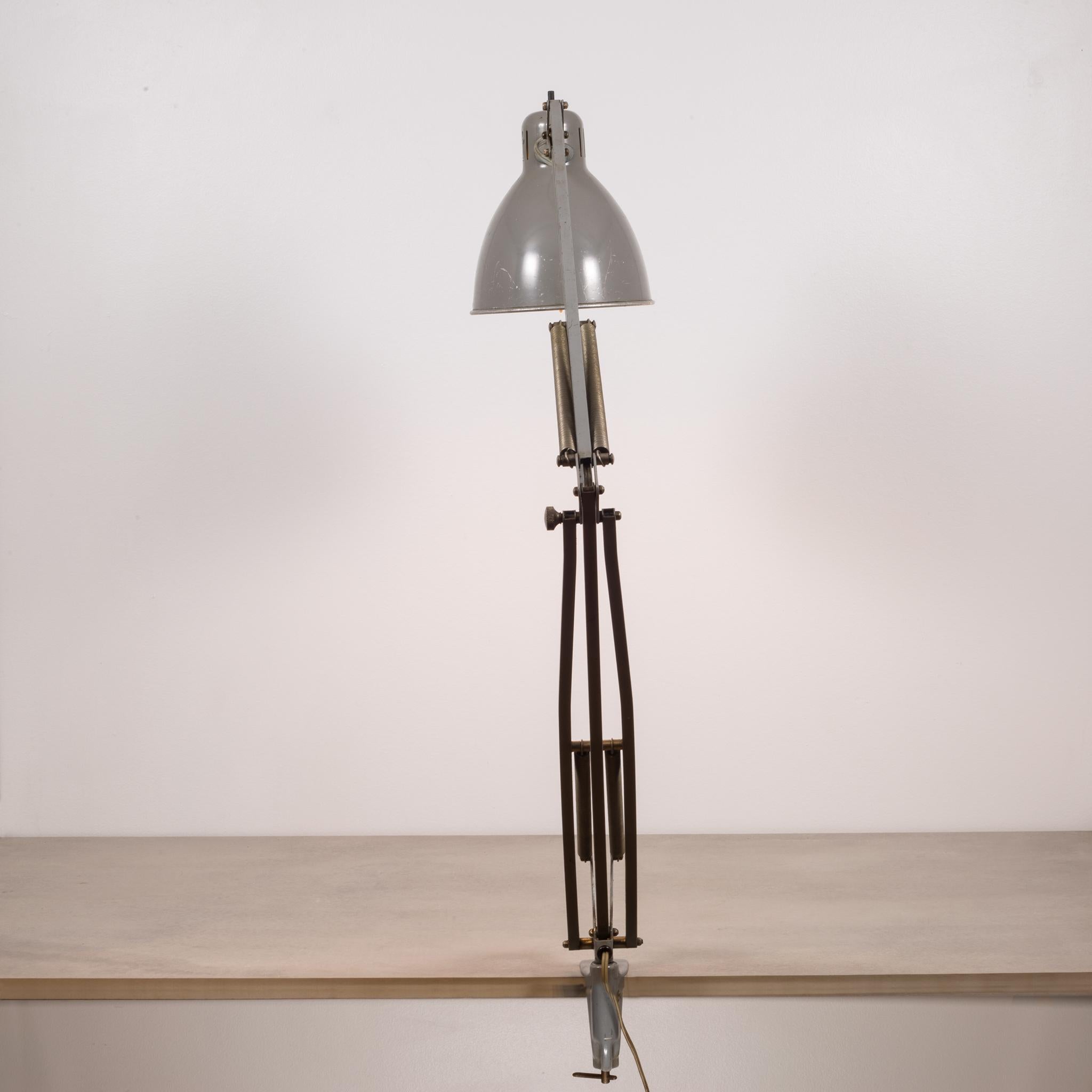 About:

This is an original midcentury Luxo L-1 task lamp. The shade and body are lacquered steel with a large articulating arm. Original label is inside the shade. This piece has retained its original finish and has the appropriate patina for the
