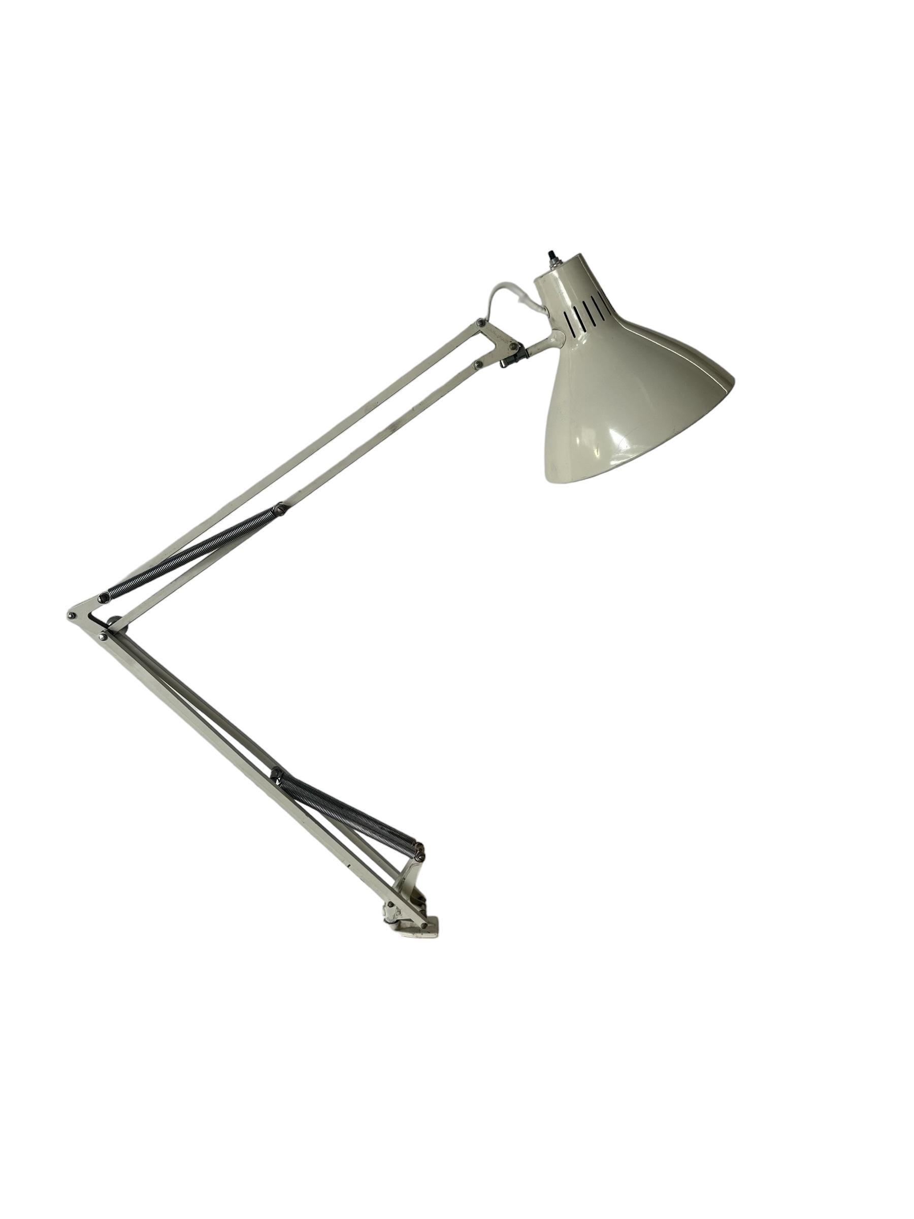 Classic Luxo articulating drafting lamp. Long a staple in any architect’s office, but equally efficient for a modern bedroom, desk, home studio, or task lamp. Rewired and accommodating modern style bulbs. In good condition with normal wear, presents