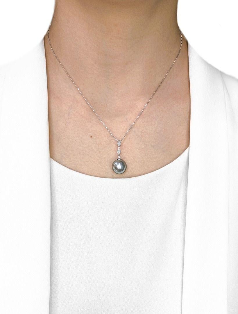 Elevate your elegance with this luxurious pendant, featuring a captivating 12.4mm round South Sea pearl, renowned for its exquisite, rare gray hue and exceptional luster. Expertly set in radiant 18K white gold, this magnificent pearl is gracefully