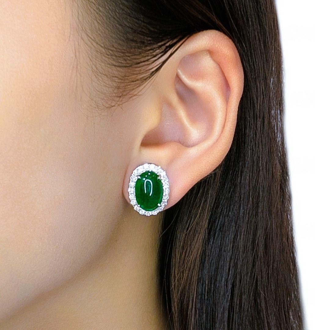 Adorn your ears with the exquisite elegance of these NGI Certified halo stud earrings, meticulously crafted in radiant 18K white gold. Each earring features a captivating oval jade main stone, measuring an impressive 10.8MM in length by 7.2MM in