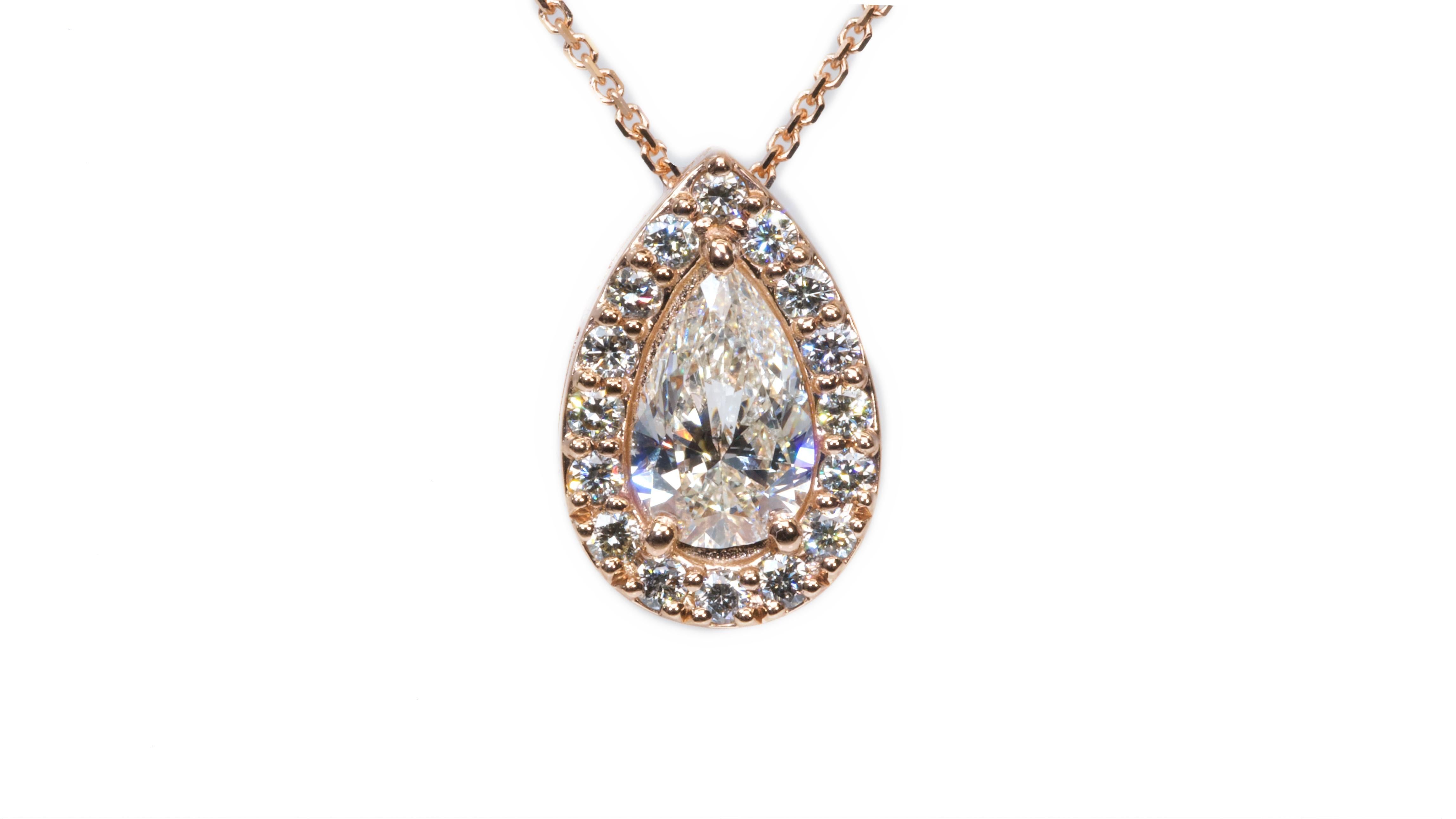 Beautiful pear shape diamond with ideal cut and perfect ratio with a 0.80 carat mounted in a halo setting with extra 0.25 carat extra round brilliant diamonds mounted in a 18k Rose gold ring with the center diamond comes with IGI certificate and
