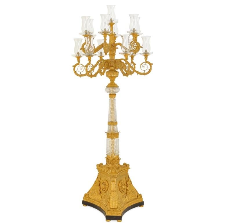 This magnificent Empire-style torchère is more than just a source of illumination; it is a powerful statement of imperial grandeur and artistic mastery. Imagine it standing sentinel in a grand salon, its thirteen arms branching out like the limbs of