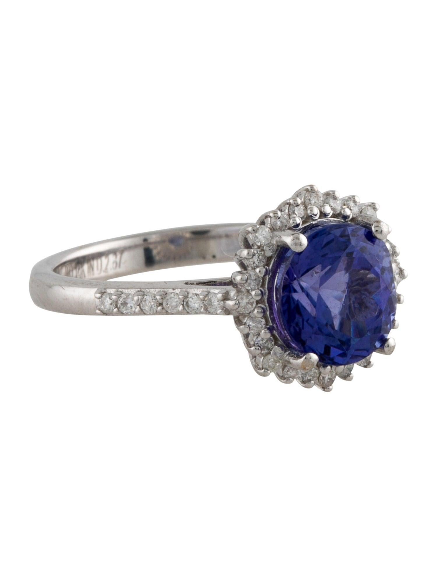 Embrace the allure of sophistication with our 14K White Gold Tanzanite and Diamond Cocktail Ring, designed for those who appreciate the beauty of fine jewelry. This stunning piece features a central 2.25 carat round faceted Tanzanite, exuding a deep