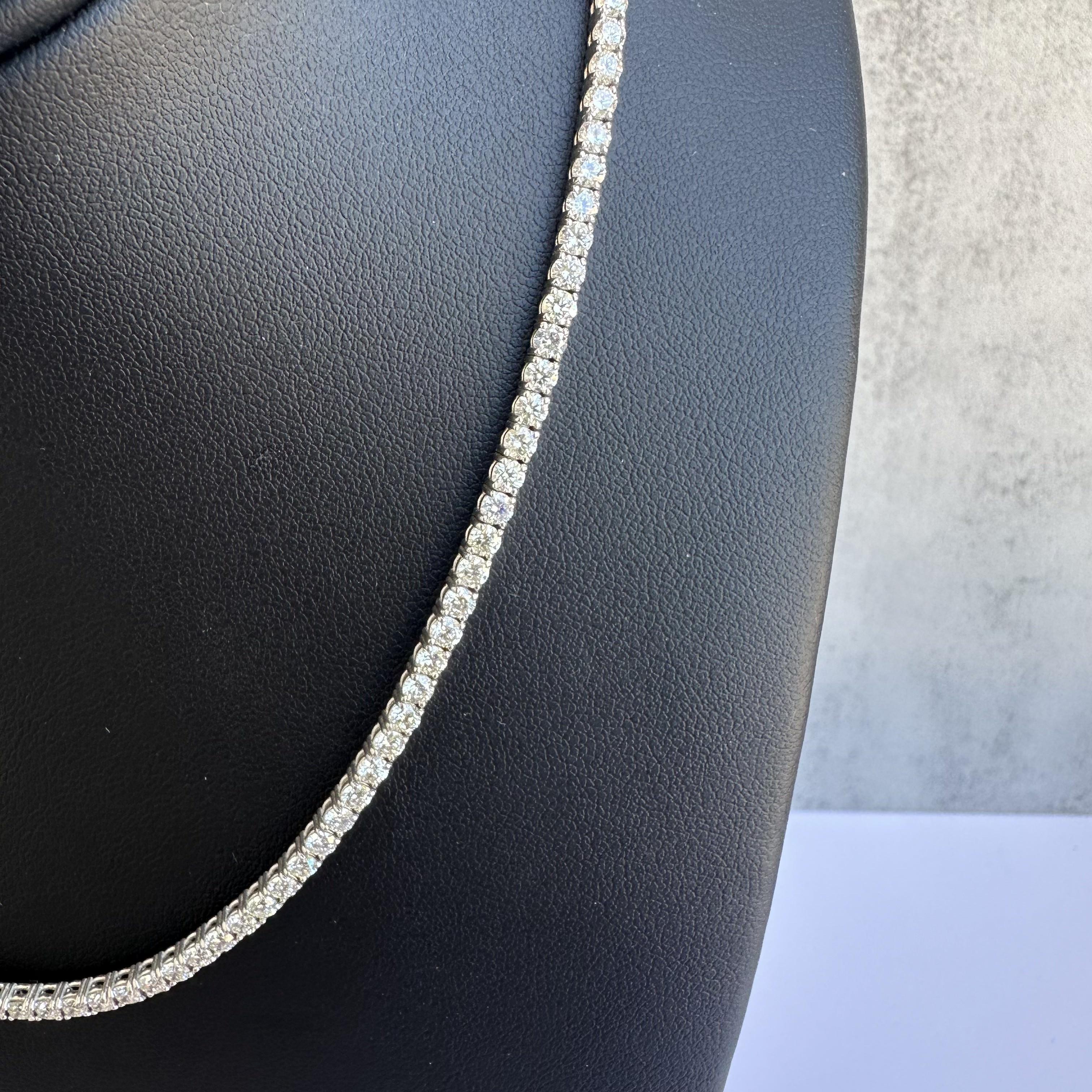 Indulge in the luxurious elegance of this 14kt White Gold Diamond Tennis Choker Necklace, featuring 6.55 carats of HI color, SI clarity natural round diamonds. This exquisite piece combines timeless sophistication with a contemporary flair, making