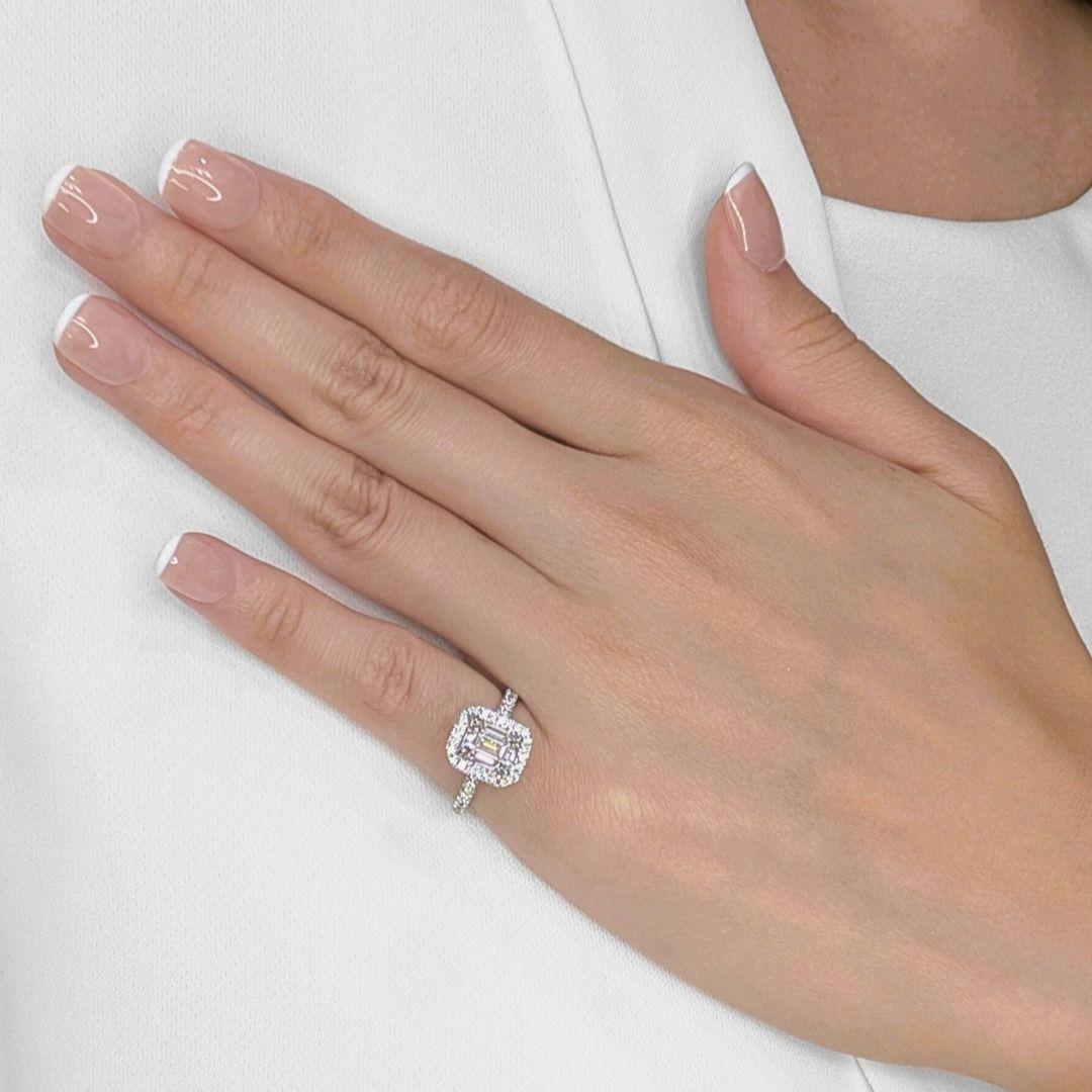 A masterpiece of elegance and craftsmanship, this MOUAWAD halo pave ring showcases a breathtaking 1.45ct emerald-cut natural diamond, graded H color and VS2 clarity, at its center. Surrounding it, 48 round brilliant-cut diamonds, totaling 0.41