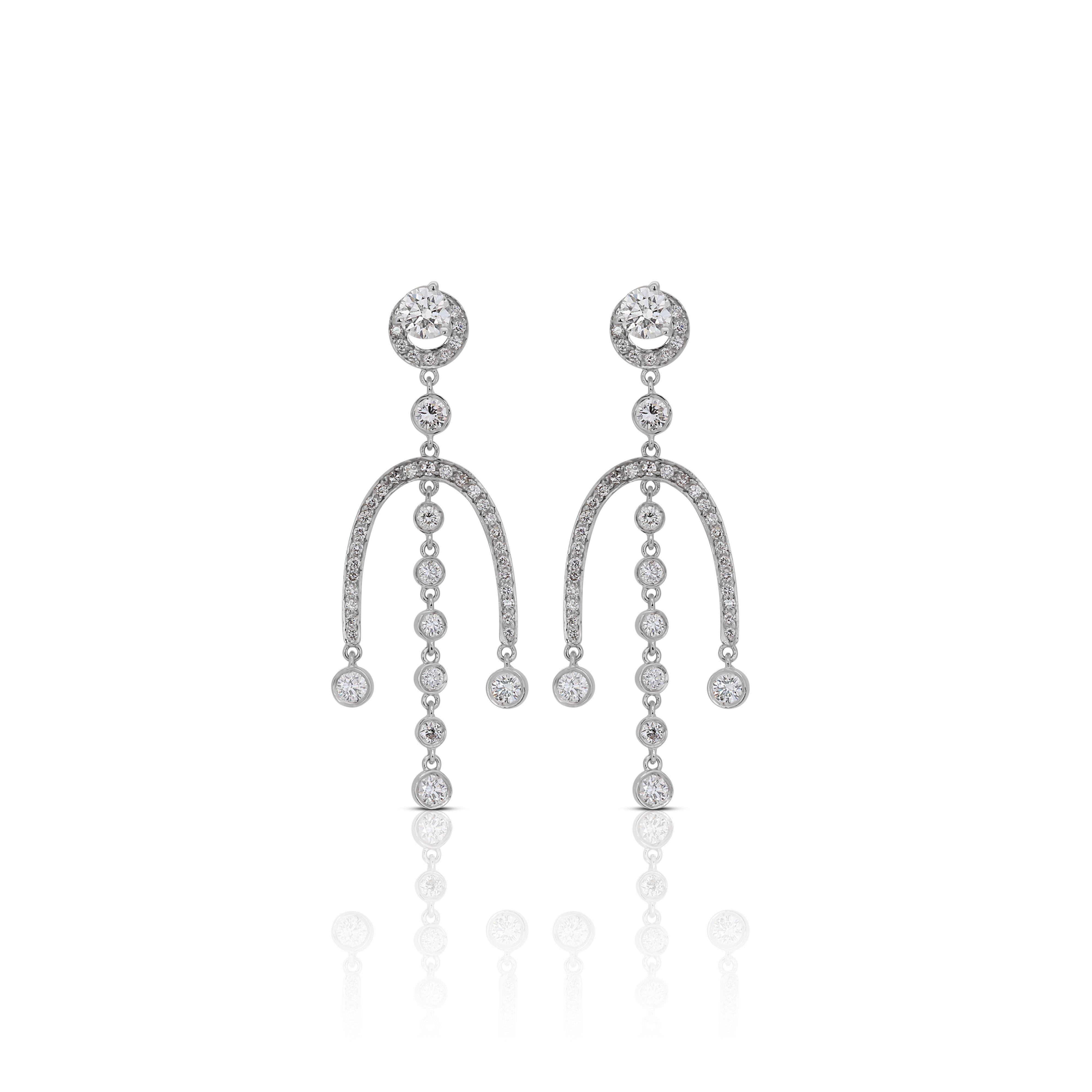 Crafted with precision, the 18K white gold setting provides a lustrous and modern backdrop for the diamonds, enhancing their brilliance and creating a luxurious aesthetic. The elegant and elongated design of the dangling earrings exudes a sense of