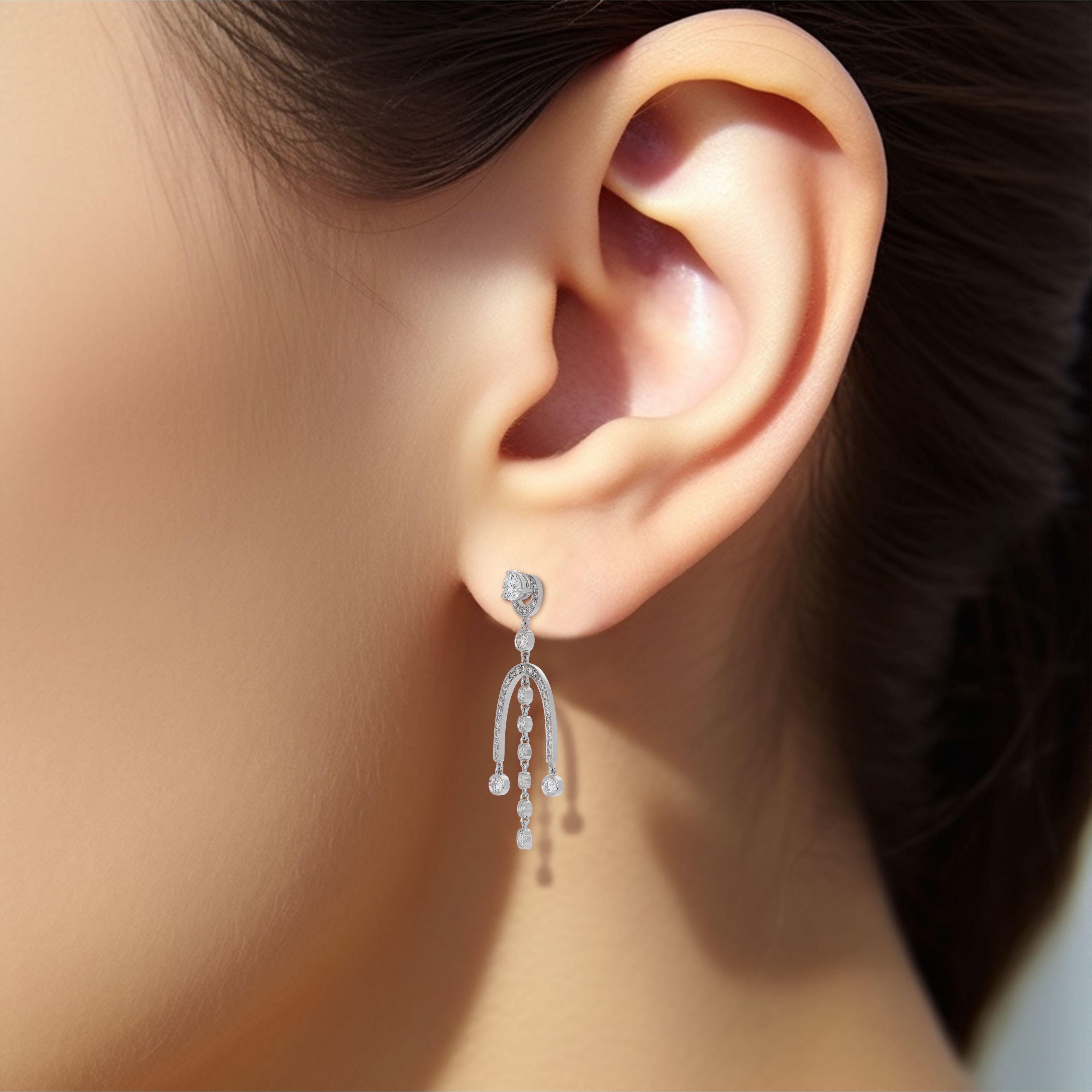 Crafted with precision, the 18K white gold setting provides a lustrous and modern backdrop for the diamonds, enhancing their brilliance and creating a luxurious aesthetic. The elegant and elongated design of the dangling earrings exudes a sense of