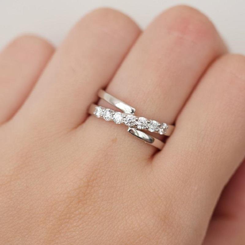 The intricately designed band adds a touch of sophistication to the piece, showcasing the fine artistry that went into its creation. The smooth lines and attention to detail make this ring a perfect blend of classic and contemporary styles. Whether