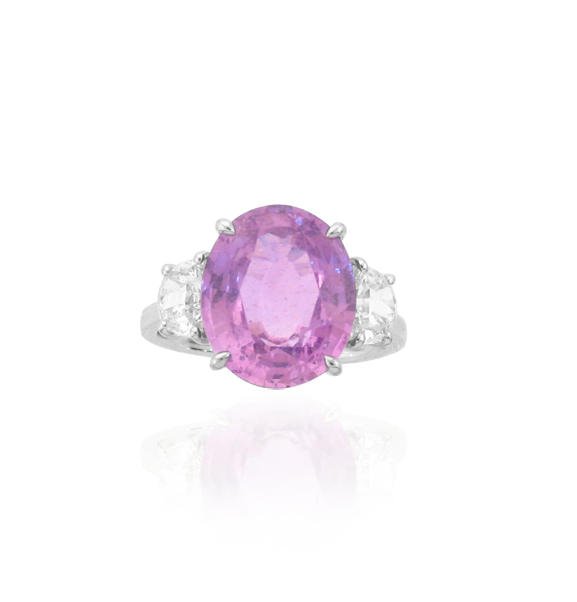 Beautiful 3 Stone Pink Sapphire Ring. Stones are from Sri Lanka, and design is based off of modern 3 stone rings. 

Pink Sapphire - 8.50ct
Half Moon Diamonds - 1.10ct
Ring Metal - 18k White Gold