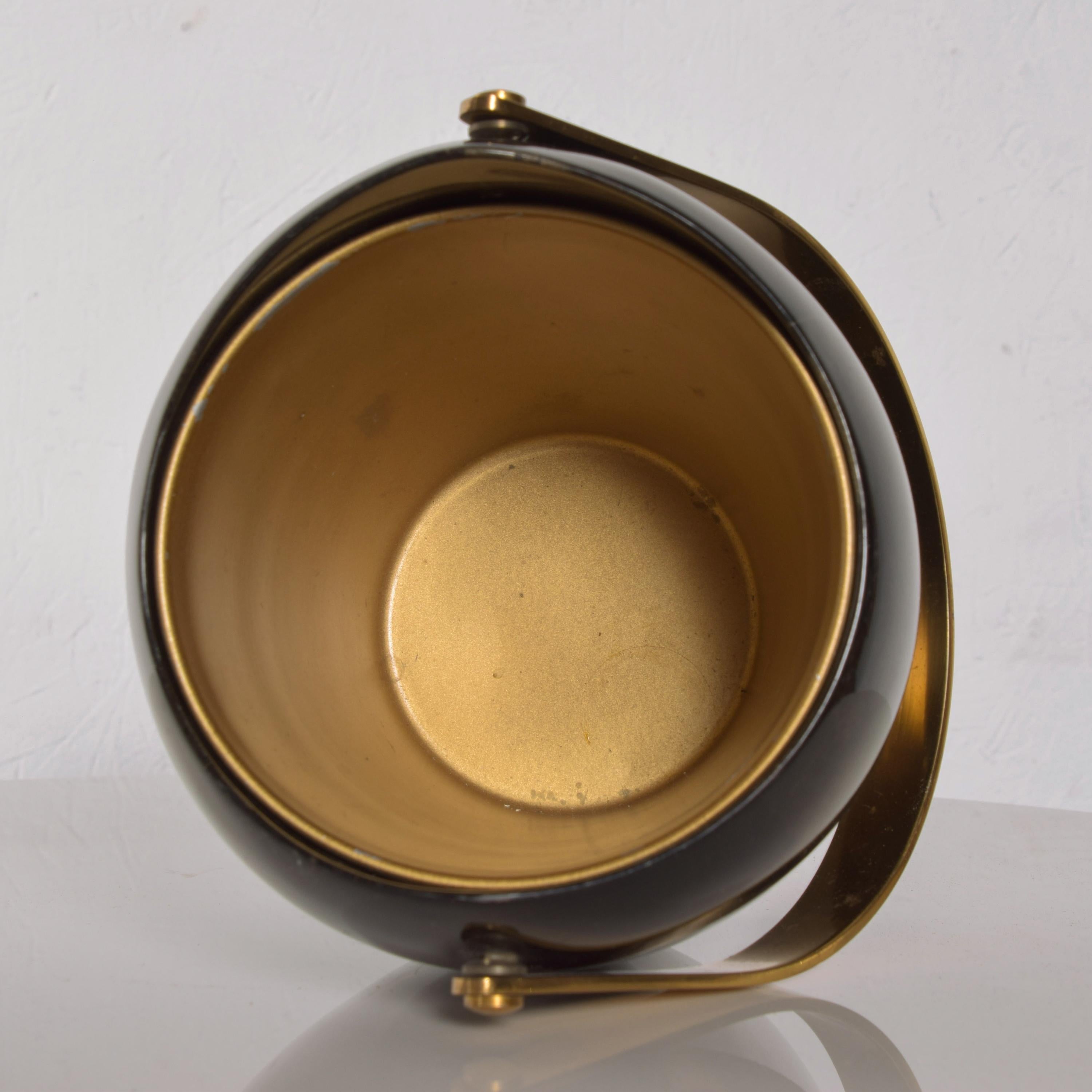 Ice Bucket
Luxurious Aldo Tura sculptural Italian ice bucket in goatskin & brass, ITALY 1960s
Interior of bucket is lustrous gold
Elegant sculptural goatskin with a brass handle. 
Stamped underneath Tura label. 
Color is dark green-gray.
Measures: