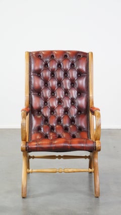 Luxurious and classic red flame-grained English leather chesterfield armchair