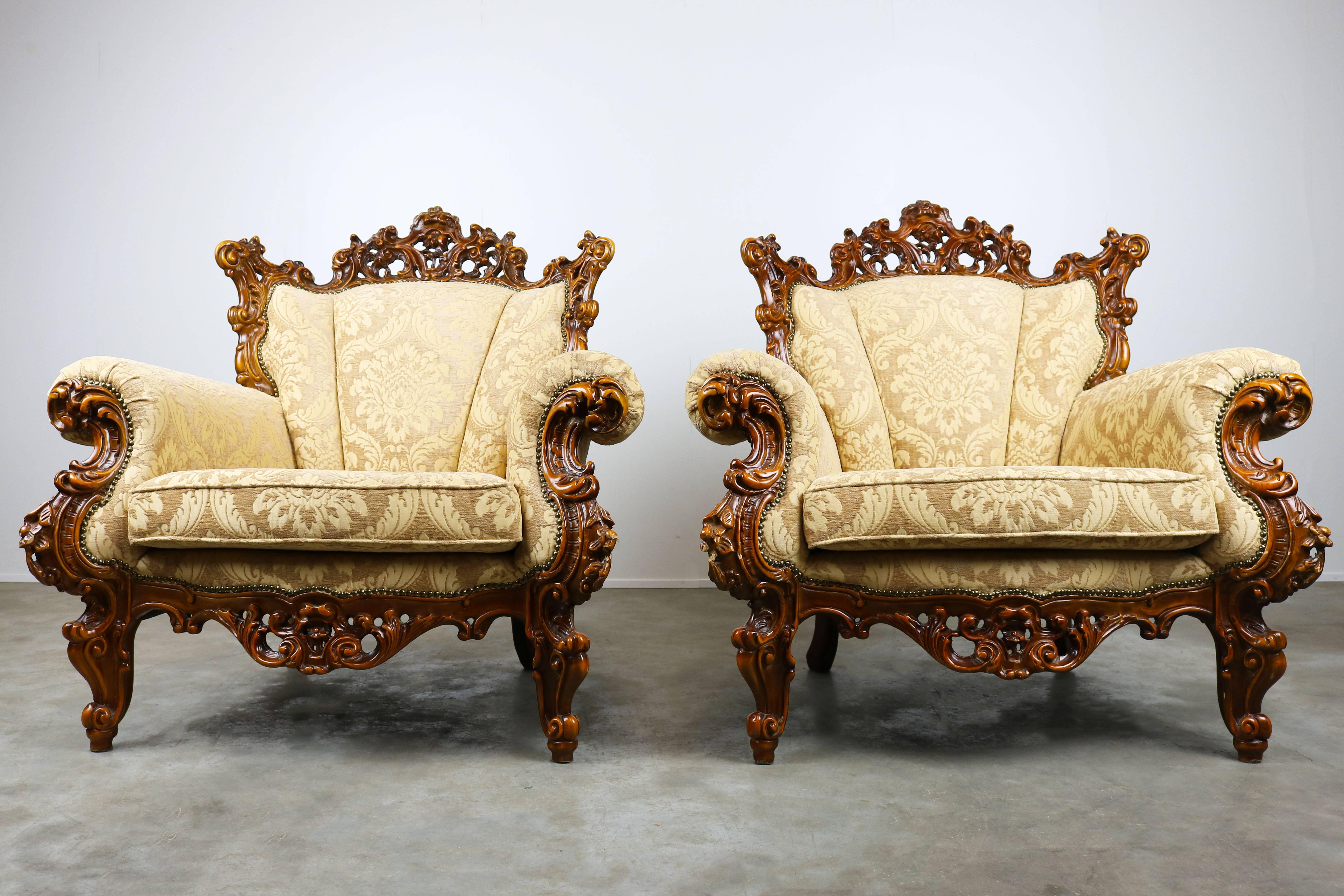 A wonderful pair of luxurious antique Italian lounge chairs in Rococo / Baroque style. The chairs are recently re-upholstered and have a royal and warm feeling. They are very comfortable and in perfect shape. Great eye catchers for any living room.