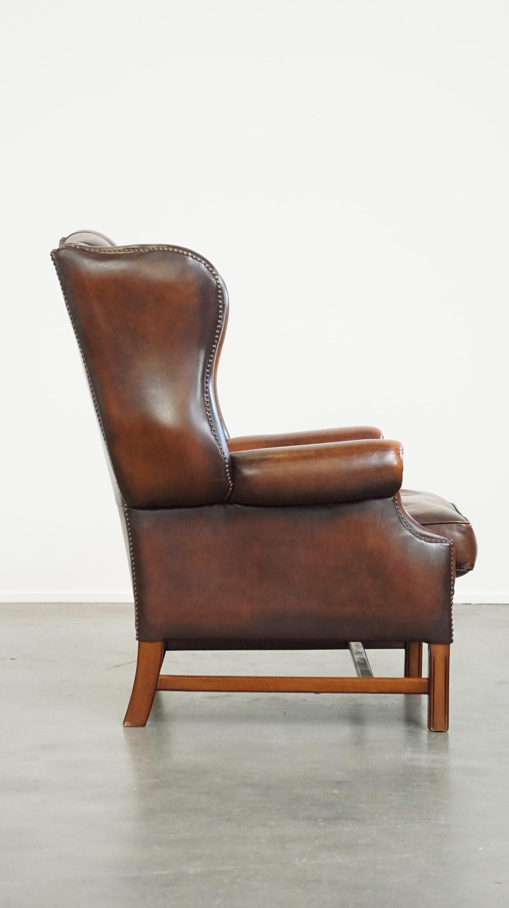 Chesterfield Luxurious brown leather chesterfield armchair finished with decorative nails For Sale